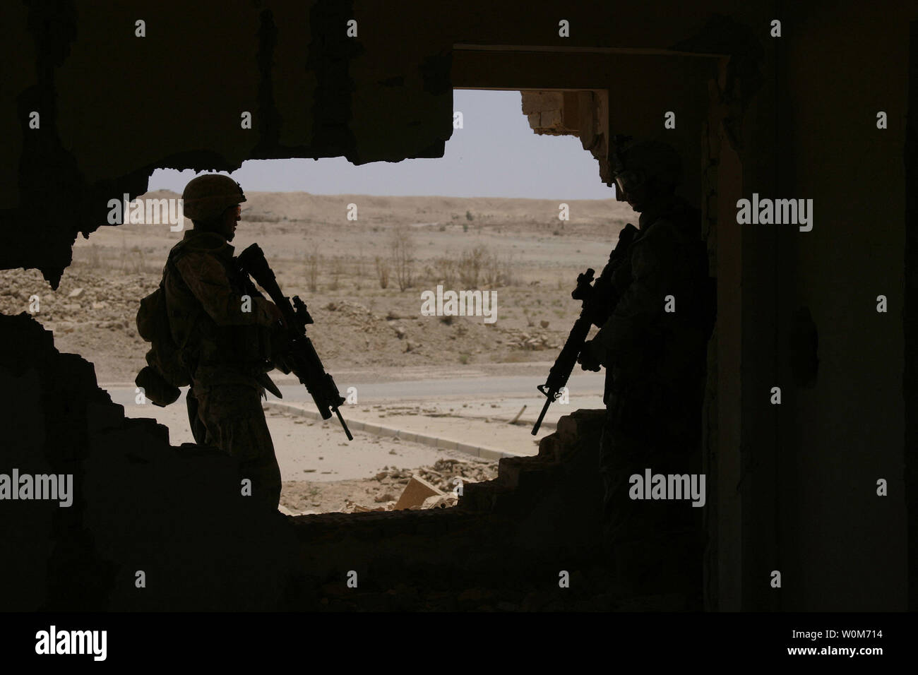 Marines of 1st Battalion, 6th Marines, clear a house as a they look for weapons  caches and signs of insurgency during an operation at Tharthar Lake, Iraq, on June 19, 2005.  (UPI {Photo/Corporal Robert R. Attebury/Marines) Stock Photo