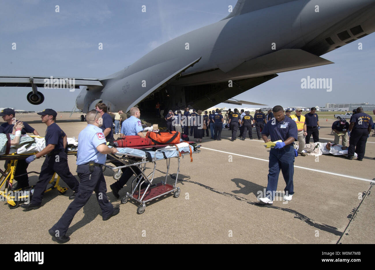 Hospital patients from Beaumont, Texas, are taken off a C-5 Galaxy from the 21st Airlift Wing, Travis Air Force Base, CA, en route to one of the many medical facilities set up to care for evacuees from the path of Hurricane Rita, on September 23, 2005 in Dallas Texas.   (UPI Photo/ Jennifer C. Wallis) Stock Photo