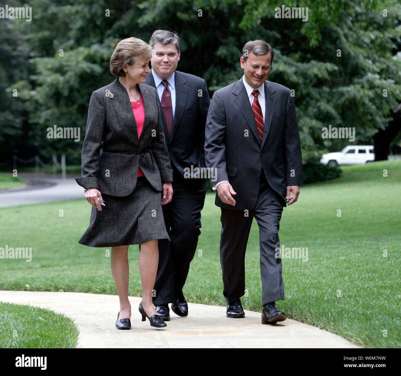 Harriet Miers escorts Supreme Court Associate Justice Nominee John G. Roberts Jr. South Lawn sidewalk en route the Oval Office to meet with President Bush on July 19, 2005 in Washington.  President Bush nominated Miers to fill Sandra Day O'Conner's seat on the Supreme Court.    (UPI Photo/Eric Draper/White House) Stock Photo