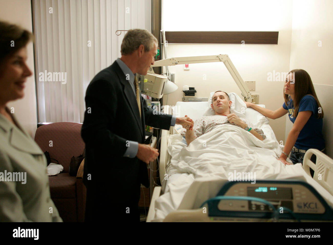 President George W. Bush shakes the hand of SPC Jeremy Goodman of Washington, N.C., as his wife, Terry Goodman, looks on Wednesday, Oct. 5, 2005, during a visit by the President and Mrs. Bush to Walter Reed Army Medical Center in Washington D.C.Ê (UPI Photo/ Paul Morse/White House) Stock Photo