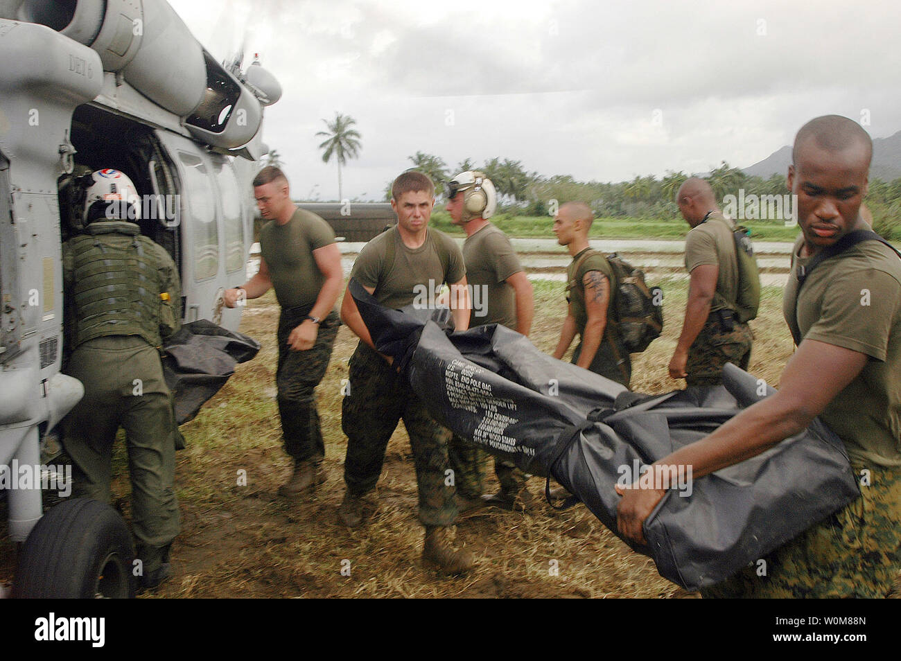 U.S. Marines unload a SH-60 Seahawk helicopter delivering supplies and equipment to the village of Guinsahugon, on the island of Leyte, Philippines, on February 21, 2006. Navy personnel are providing assistance and disaster relief efforts on the Island of Leyte, following the Feb. 17 landslide that devastated the town of Guinsahugon located in the southern part of the island.    (UPI Photo/NVNS Photographer Justin Park) Stock Photo