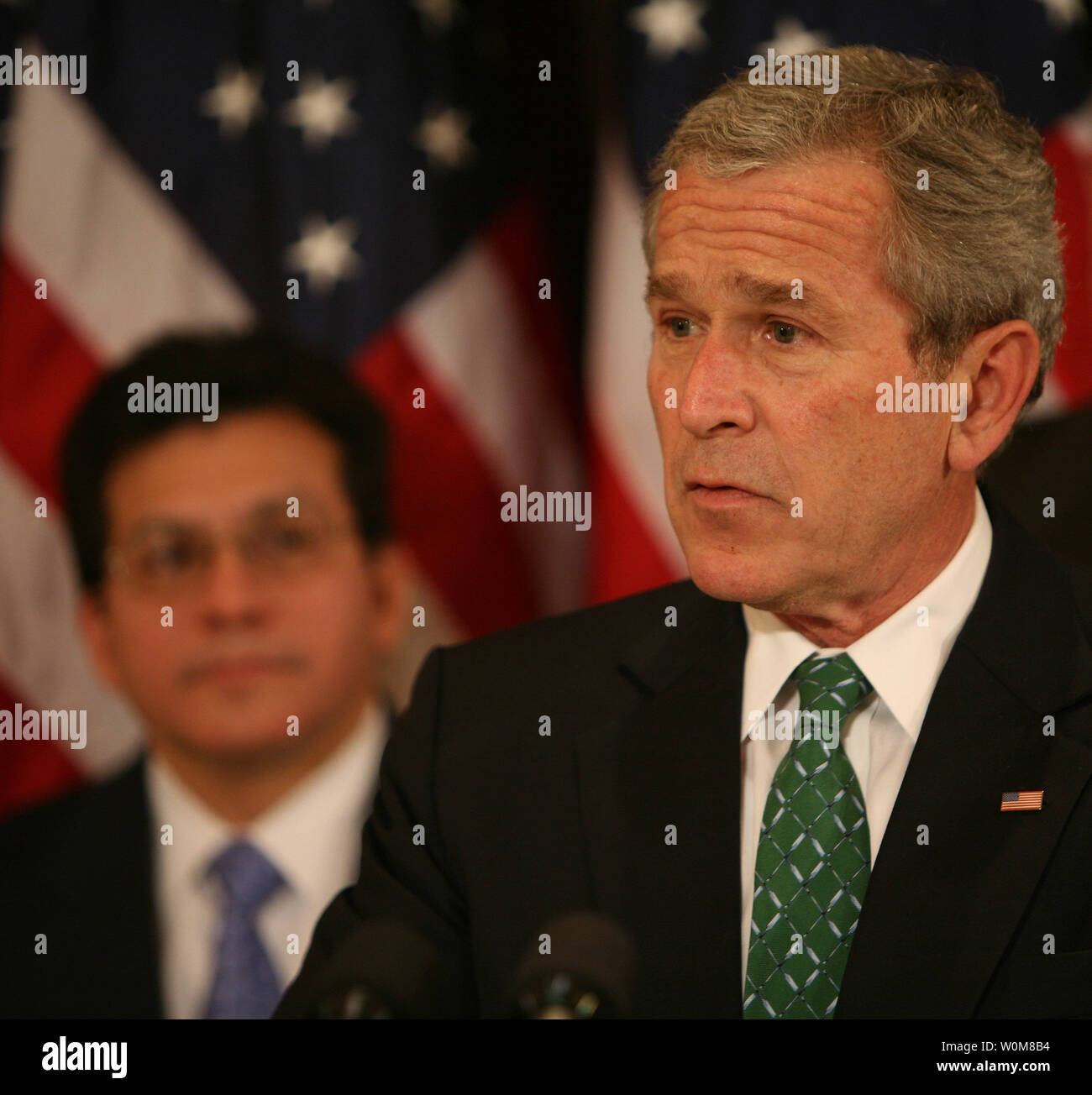 Attorney General Alberto Gonzales watches President George W. Bush speak before the signing of H.R. 32, the Stop Counterfeiting in Manufactured Goods Act in the Eisenhower Executive Office Building on March 16, 2006.  Agency pool  by Dennis Brack, Black Star Stock Photo