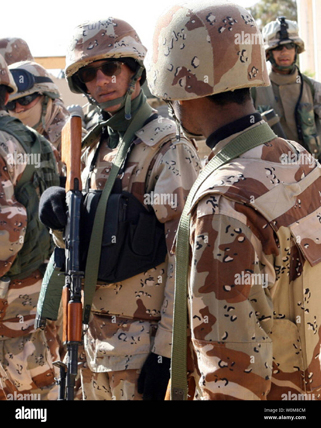 Iraqi Army soldiers load their weapons and conduct a final gear inspection prior to embarking on a security patrol with Marines from Animal Company, 1st Battalion, 7th Marine Regiment, in the town of Ubayde, Iraq in western Al Anbar Province, March 20, 2006.  (UPI Photo/Cpl. Antonio Rosas/USMC) Stock Photo