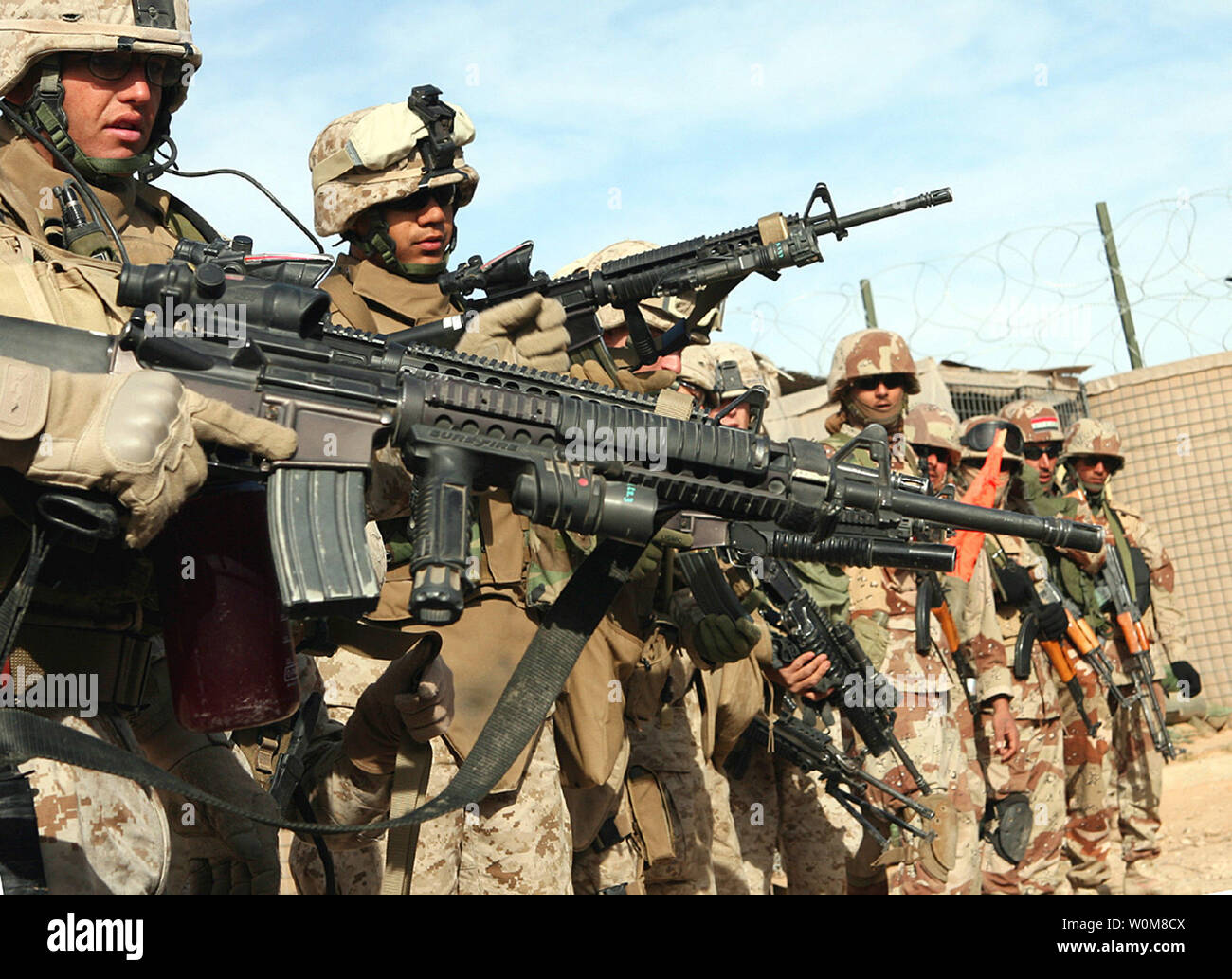 Iraqi Army soldiers and Marines from Company A, 1st Battalion, 7th Marine Regiment, conduct a security patrol in the town of Ubayde, Iraq in western Al Anbar Province, March 20, 2006.   (UPI Photo/Cpl. Antonio Rosas/USMC) Stock Photo