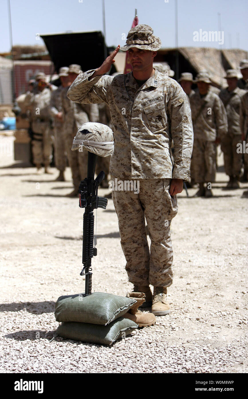 Capt. John Black, commanding officer for Weapons Company, 1st Battalion, 7th Marine Regiment renders one final salute in honor of two Marines and one sailor who lost their lives while conducting security operations in a village near the Iraq-Syria border earlier this month. Their vehicle hit a mine on one of the regions dangerous roadways June 11, 2006. The three servicemen from the Battalion’s Weapons Company were given a memorial service June 14, 2006, at the outpost; Marines call them ‘battle positions,’ where the men worked alongside Iraqi soldiers. Lance Cpl. Brent B. Zoucha, 19, a mortar Stock Photo