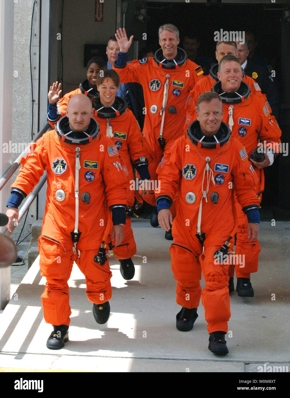 Commander Steven Lindsey (R) and Pilot Mark Kelly (L) lead Mission Specialists  Lisa Nowak (2nd Row,L), Michael Fossum (2nd row,R), Stephanie Wilson (3rd Row,L), Piers Sellers, of England (3rd Row,R), and Thomas Reiter (rear) of Germany, walk out of the Operations and Checkout Building to board the NASA Astrovan to board the Space Shuttle Discovery for mission STS-121 at Cape Canaveral, Florida on July 1, 2006.  (UPI Photo/Pat Benic) Stock Photo