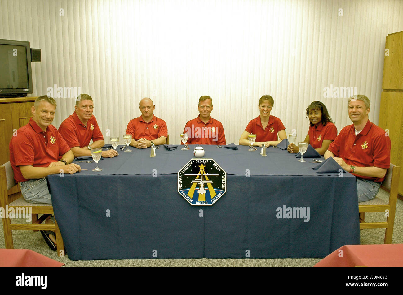 The mission STS-121 crew gathers for the traditional breakfast before they suit up for launch July 1, 2006. Seated left to right are Mission Specialists Piers Sellers and Michael Fossum, Pilot Mark Kelly, Commander Steven Lindsey, and Mission Specialists Lisa Nowak, Stephanie Wilson and Thomas Reiter, who represents the European Space Agency. The launch of Space Shuttle Discovery on mission STS-121 is the 115th shuttle flight and the 18th U.S. flight to the International Space Station. During the 12-day mission, the STS-121 crew will test new equipment and procedures to improve shuttle safety, Stock Photo
