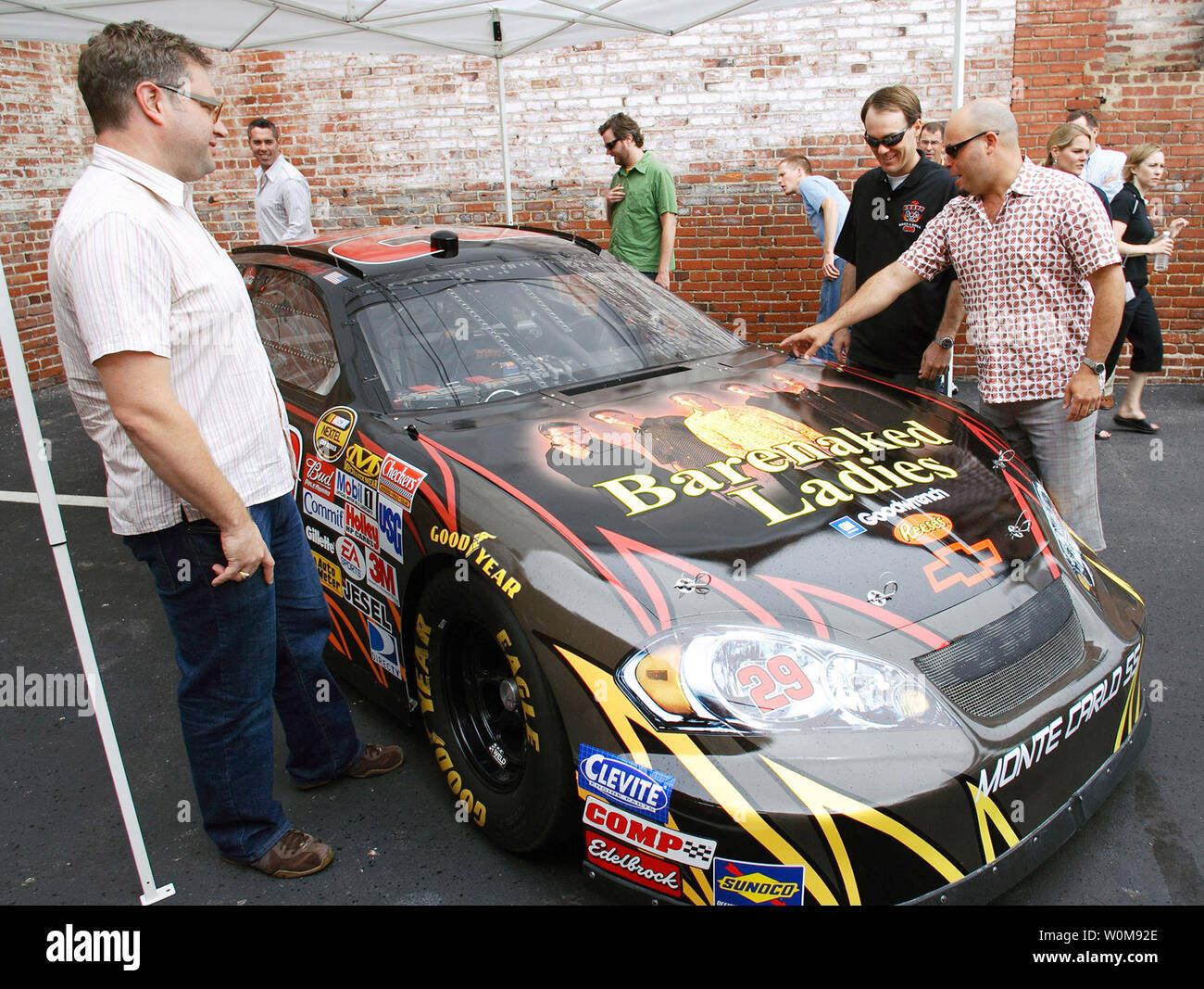 Members of the band Barenaked Ladies meet with NASCAR driver Kevin Harvick (center) to get a good look at the #29 GM Goodwrench Chevy Monte Carlo SS racecar with images of the Barenaked Ladies band on the hood at XM Satellite Radio headquarters in Washington, DC on July 13, 2006. Chevrolet announced the Barenaked Ladies will perform the pre-race concert at the Chevy Rock & Roll 400. The race, that takes place September 9 at Richmond International Raceway, will feature Harvick in the Barenaked Ladies racecar. (UPI Photo/Tyler Mallory/General Motors) Stock Photo