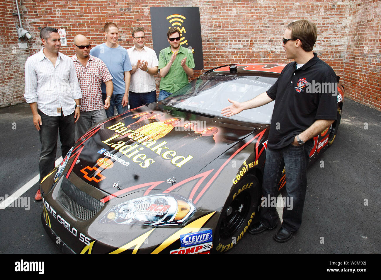 Members of the band Barenaked Ladies meet with NASCAR driver Kevin Harvick (right) to get a good look at the #29 GM Goodwrench Chevy Monte Carlo SS racecar with images of the Barenaked Ladies band on the hood at XM Satellite Radio headquarters in Washington, DC on July 13, 2006. Chevrolet announced the Barenaked Ladies will perform the pre-race concert at the Chevy Rock & Roll 400. The race, that takes place September 9 at Richmond International Raceway, will feature Harvick in the Barenaked Ladies racecar.  (UPI Photo/Tyler Mallory/General Motors) Stock Photo