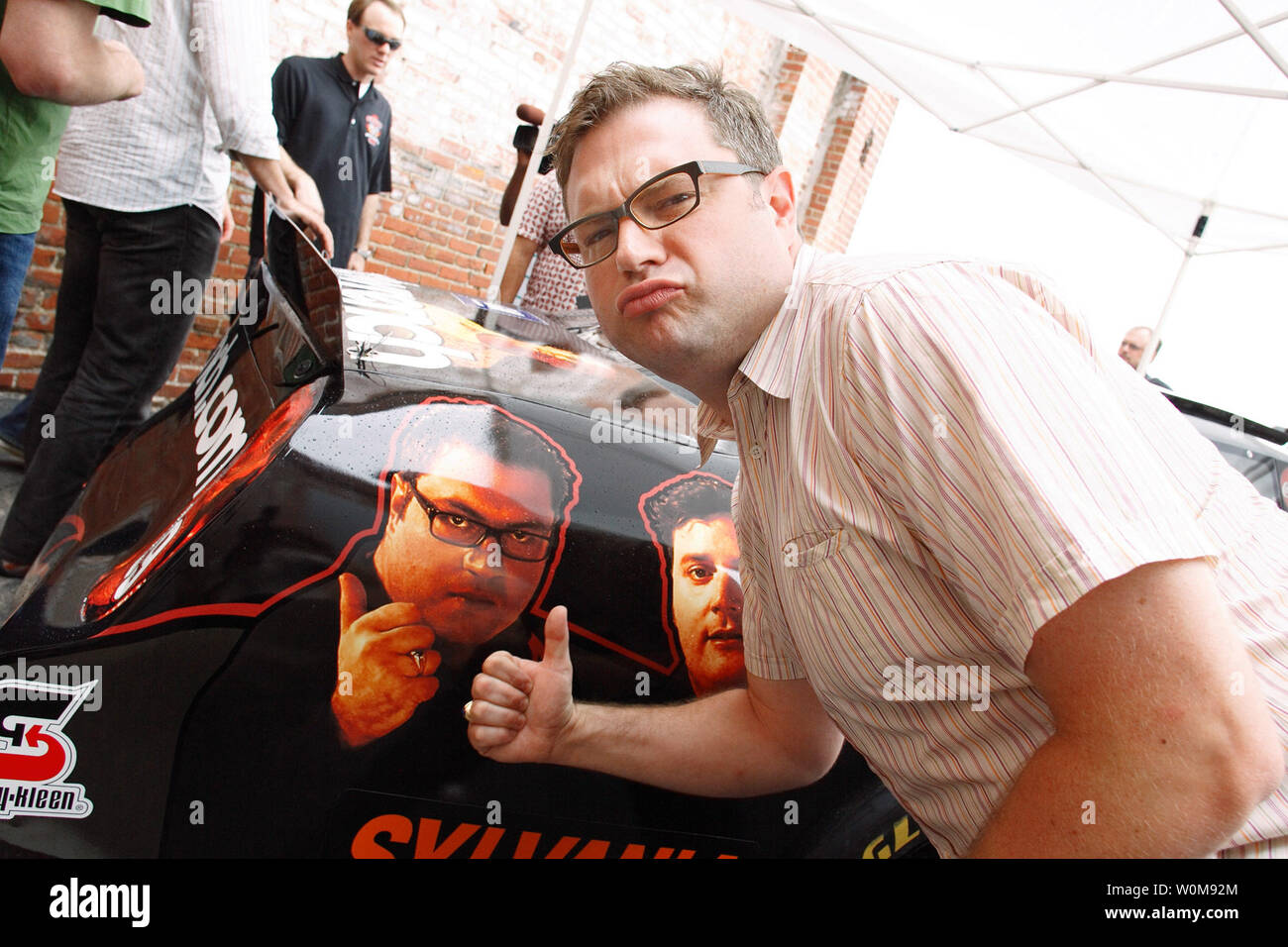 Steven Page of the band Barenaked Ladies approves of his photo on NASCAR driver Kevin Harvick's #29 GM Goodwrench Chevy Monte Carlo SS racecar at XM Satellite Radio headquarters in Washington, DC on July 13, 2006. Chevrolet announced the Barenaked Ladies will perform the pre-race concert at the Chevy Rock & Roll 400. The race, that takes place September 9 at Richmond International Raceway, will feature Harvick in the Barenaked Ladies racecar. (UPI Photo/Tyler Mallory/General Motors) Stock Photo