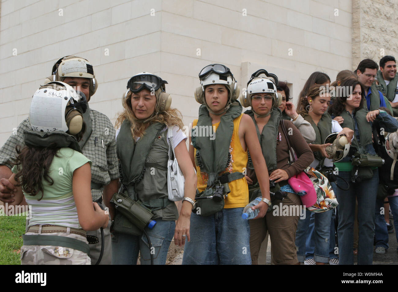 U.S. citizens put on their cranial helmets and life preservers as they wait to board a CH-53 Super Stallion helicopter at the U.S. Embassy in Beirut, Lebanon, for a flight to Cyprus on July 20, 2006.  At the request of the U.S. Ambassador to Lebanon and at the direction of the Secretary of Defense, the United States Central Command and elements of Task Force 59 are assisting with the departure of U.S. citizens from Lebanon. (UPI Photo/James H. Frank/U.S. Marine Corps) Stock Photo