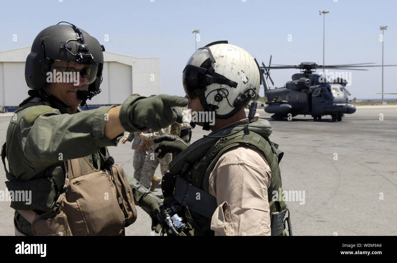 U.S. Air Force Maj. Jason Stanley, left, talks with a Marine crew member while waiting to take Secretary of State Condoleezza Rice from Cyprus to the U.S. Embassy in Beirut, Lebanon, on July 24, 2006.  Major Stanley, an MH-53M Pave Low helicopter pilot with the 352nd Special Operations Group, Royal Air Force Mildenhall, was providing escort to the Marine helicopter transporting Secretary Rice.   (UPI Photo/Brian Ferguson/USAF) Stock Photo