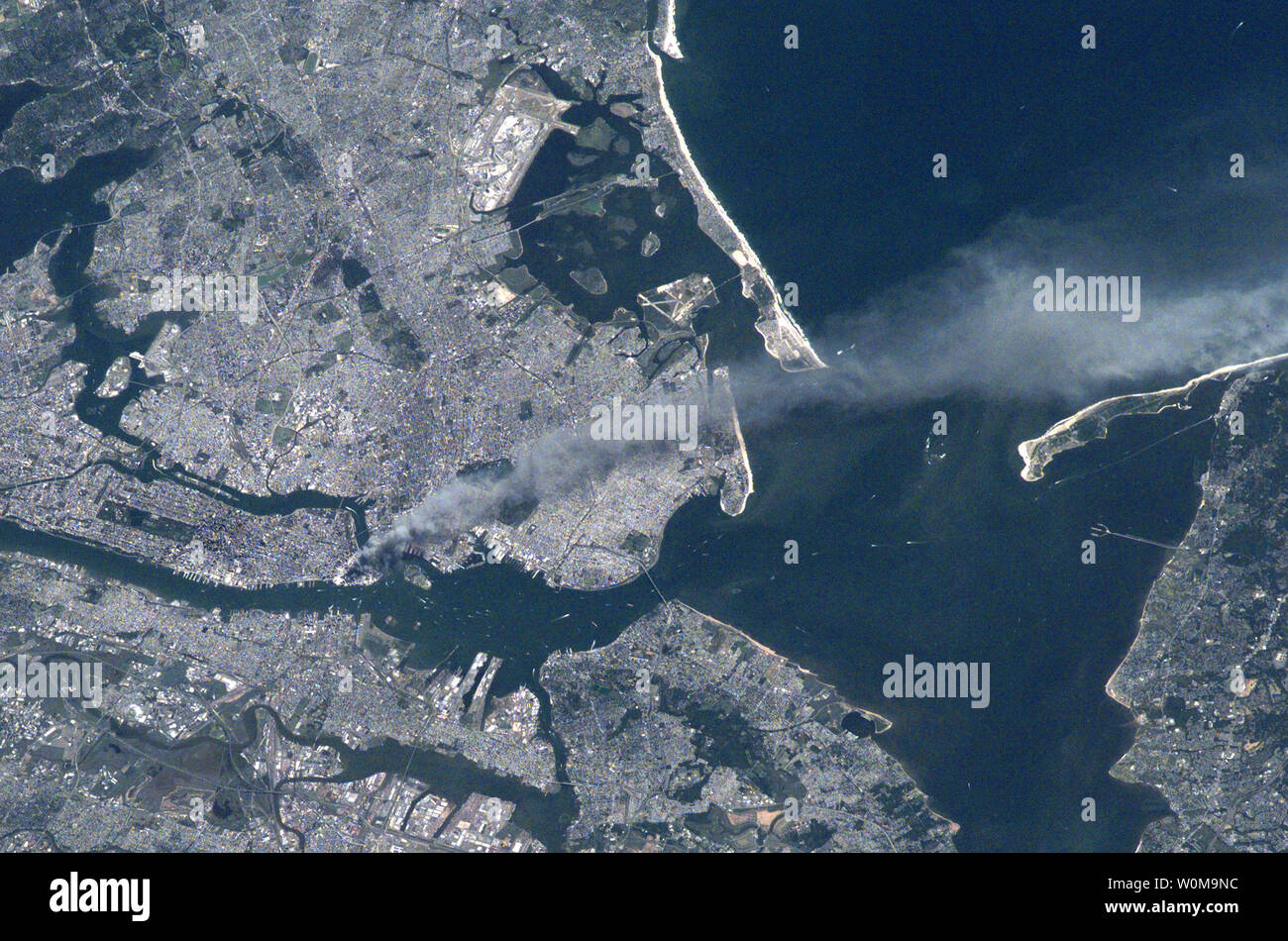 https://c8.alamy.com/comp/W0M9NC/this-image-is-one-of-a-series-taken-on-september-11-2001-that-shows-the-smoke-plume-rising-from-the-world-trade-center-towers-in-lower-manhattan-from-the-international-space-stations-expedition-3-crew-new-jersey-is-seen-in-the-lower-part-of-the-picture-and-the-upper-part-is-brookly-and-queens-boroughs-of-new-york-city-upi-photonasa-W0M9NC.jpg