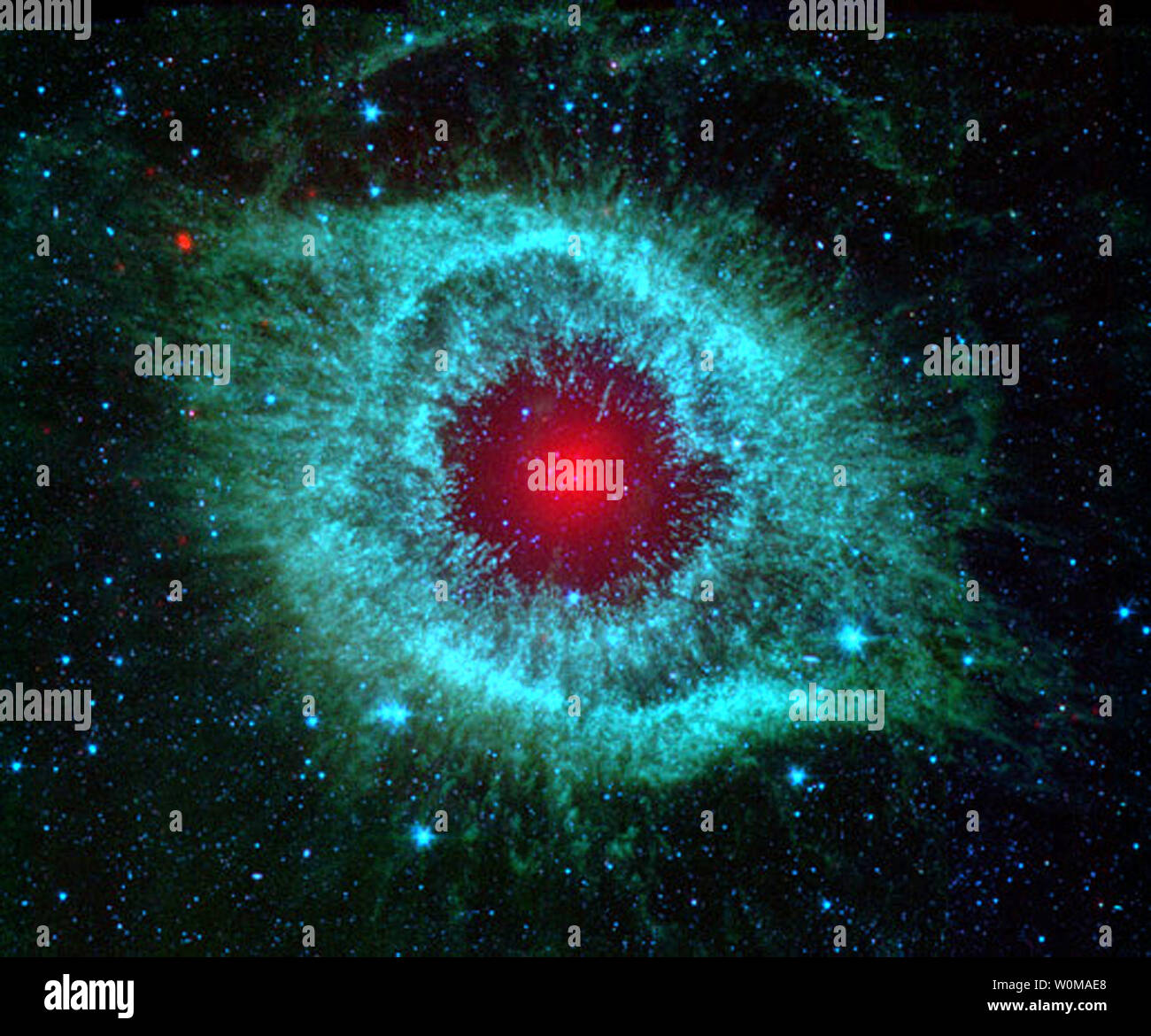 This undated infrared image from NASA's Spitzer Space Telescope shows the Helix nebula located 700 light-years away from Earth. The nebulae is the remains of a dieing, similar to the Sun, whose gaseous layers are expanding outward. (UPI Photo/NASA/JPL-Caltech/Univ.of Ariz) Stock Photo