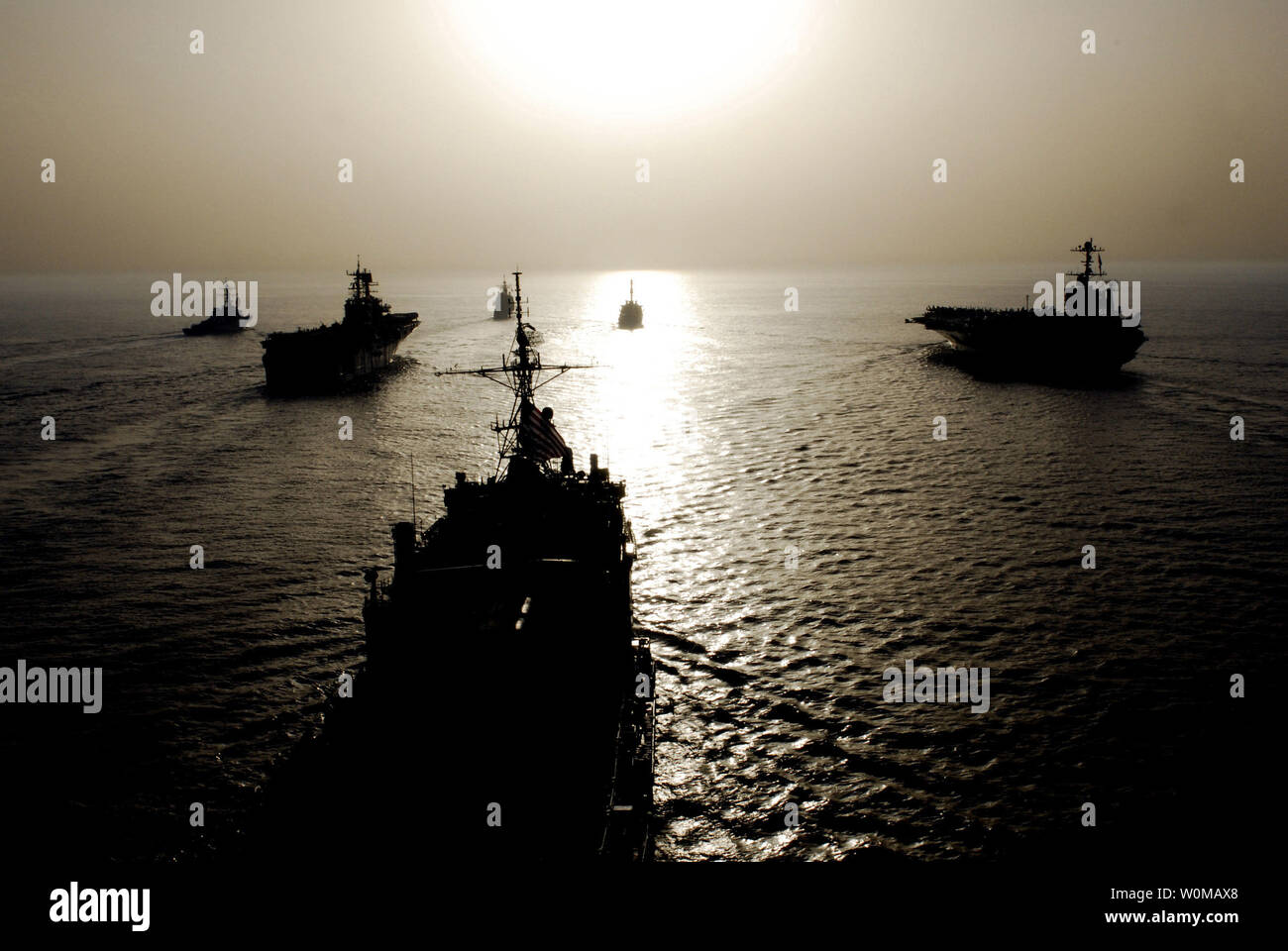 From left, USS Higgins (DDG 76), USS Bonhomme Richard (LHD 6), USS Antietam (CG 54), USS Denver (LPD 9), USS O'Kane (DDG 77) and USS John C. Stennis (CVN 74) steam through the Gulf of Oman on May 22, 2007. The ships are part of three different strike groups, the John C. Stennis Carrier Strike Group, Nimitz Carrier Strike Group and the Bonhomme Richard Expeditionary Strike Group, that are on regularly scheduled deployments in support of maritime security operations. Maritime operations set the conditions for security and stability, as well as complement counter-terrorism and security efforts to Stock Photo