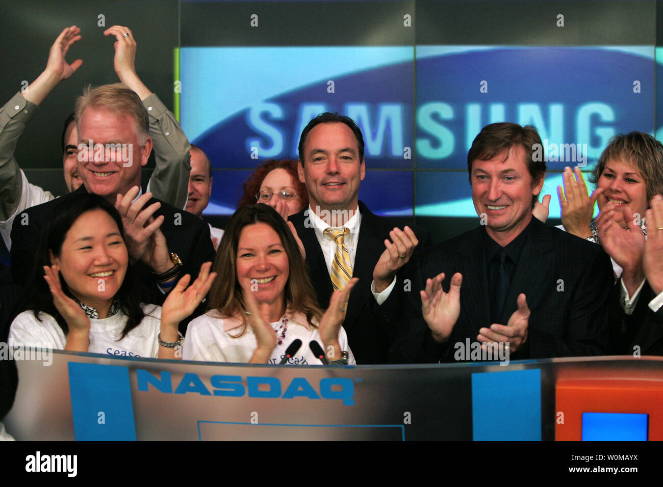 Boomer Esiason (L), Tim Baxter, Executive Vice President of Samsung  Electronics North America, (C) and Wayne Gretzky (R), presided over the  opening bell ceremonies at the NASDAQ in New York on June