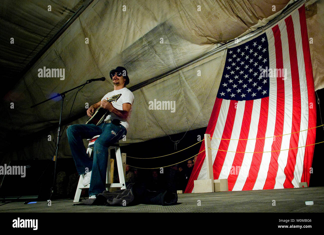 Kid Rock plays his set during the 2007 USO Holiday Tour stop at Al Taqaddum, Iraq on December 18, 2007. Navy Adm. Mike Mullen, chairman, Joint Chiefs of Staff and tour host was joined by comedians Lewis Black and Robin Williams, 7-time Tour de France champion Lance Armstrong and Miss USA Rachel Smith on the 15-stop, 7-country tour thanking the forward deployed troops for their sacrifice and service. (UPI Photo/Chad J. McNeeley/Department of Defense) Stock Photo