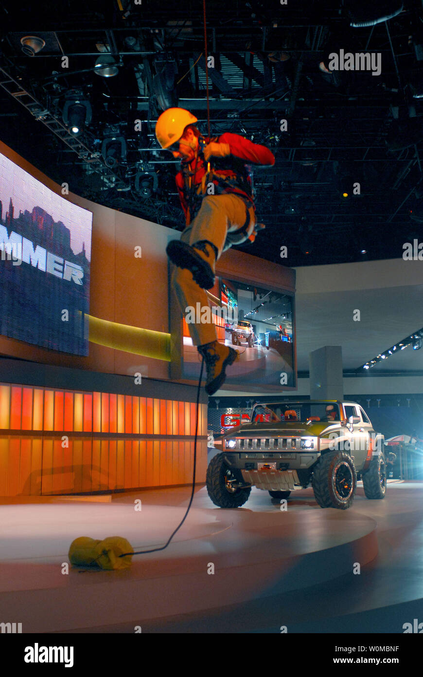 A rappeller drops from the rafters as part of the HUMMER HX Concept world introduction at the 2008 North American International Auto Show on in Detroit, Michigan on January 13, 2008. The HUMMER HX Concept is an open-air, two-door off-road vehicle that runs on E85 ethanol fuel. (UPI Photo/Steve Fecht/General Motors) Stock Photo