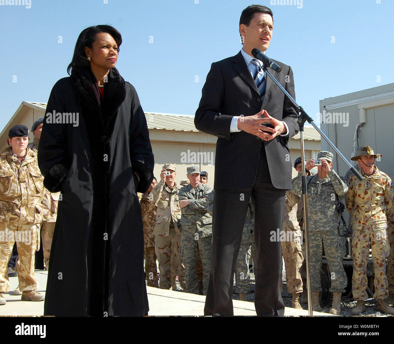 Secretary of State Condoleezza Rice (L) and British Foreign Secretary David Miliband speak to multinational troops on Kandahar Airfield in Kandahar, Afghanistan on February 7, 2008. Rice and Miliband are visiting the area to meet with troops, military leaders and top government officials. (UPI Photo/Steven Park/U.S. Navy) Stock Photo