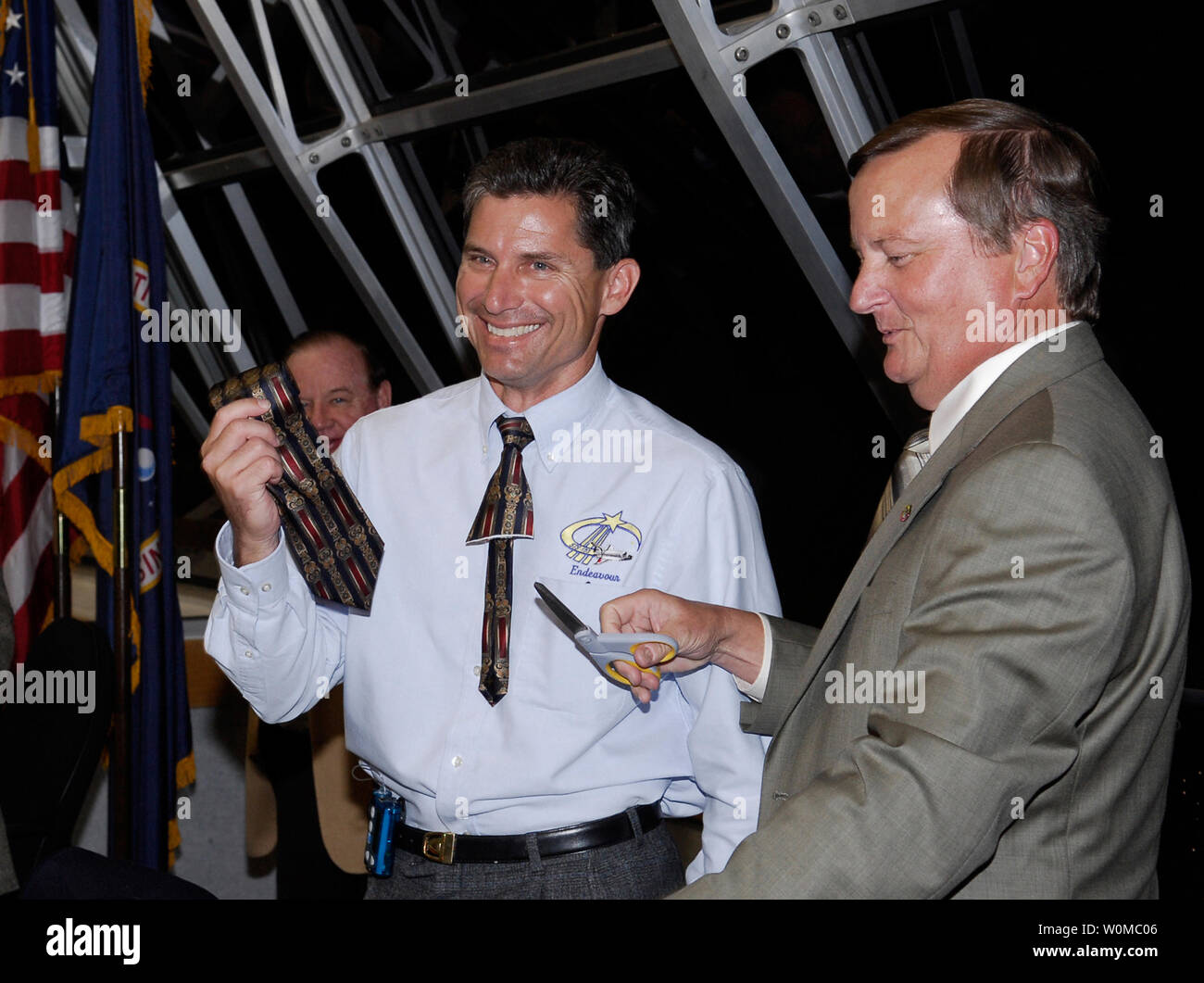 NASA Flow Director for space shuttle Endeavour, Ken Tenbusch (left) holds the tie cut by Shuttle Launch Director Mike Leinbach (right) after the successful launch of Endeavour. The tie-cutting is a tradition for first-timers.  Liftoff was on time at 2:28 a.m. EDT. The crew will make a record-breaking 16-day mission to the International Space Station and deliver the first section of the Japan Aerospace Exploration Agency's Kibo laboratory and the Canadian Space Agency's two-armed robotic system, Dextre.   (UPI Photo/NASA/Kim Shiflett) Stock Photo