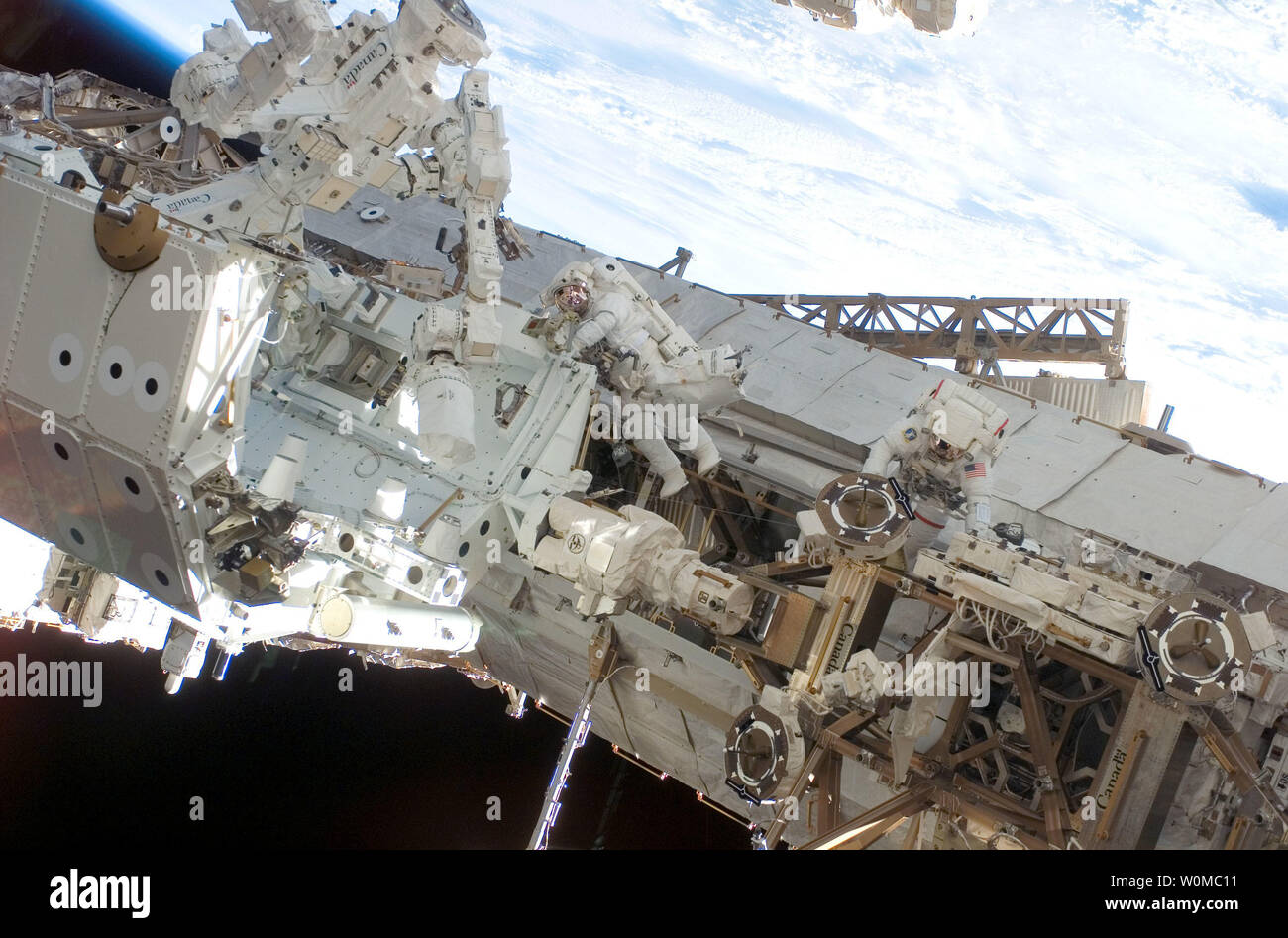 Astronauts Rick Linnehan (right) and Robert L. Behnken, both STS-123 mission specialists, participate in the mission's third scheduled session of extravehicular activity (EVA) as construction and maintenance continue on the International Space Station on March 17, 2008. During the 6-hour, 53-minute spacewalk, Linnehan and Behnken installed a spare-parts platform and tool-handling assembly for Dextre, also known as the Special Purpose Dextrous Manipulator (SPDM). (UPI Photo/NASA) Stock Photo