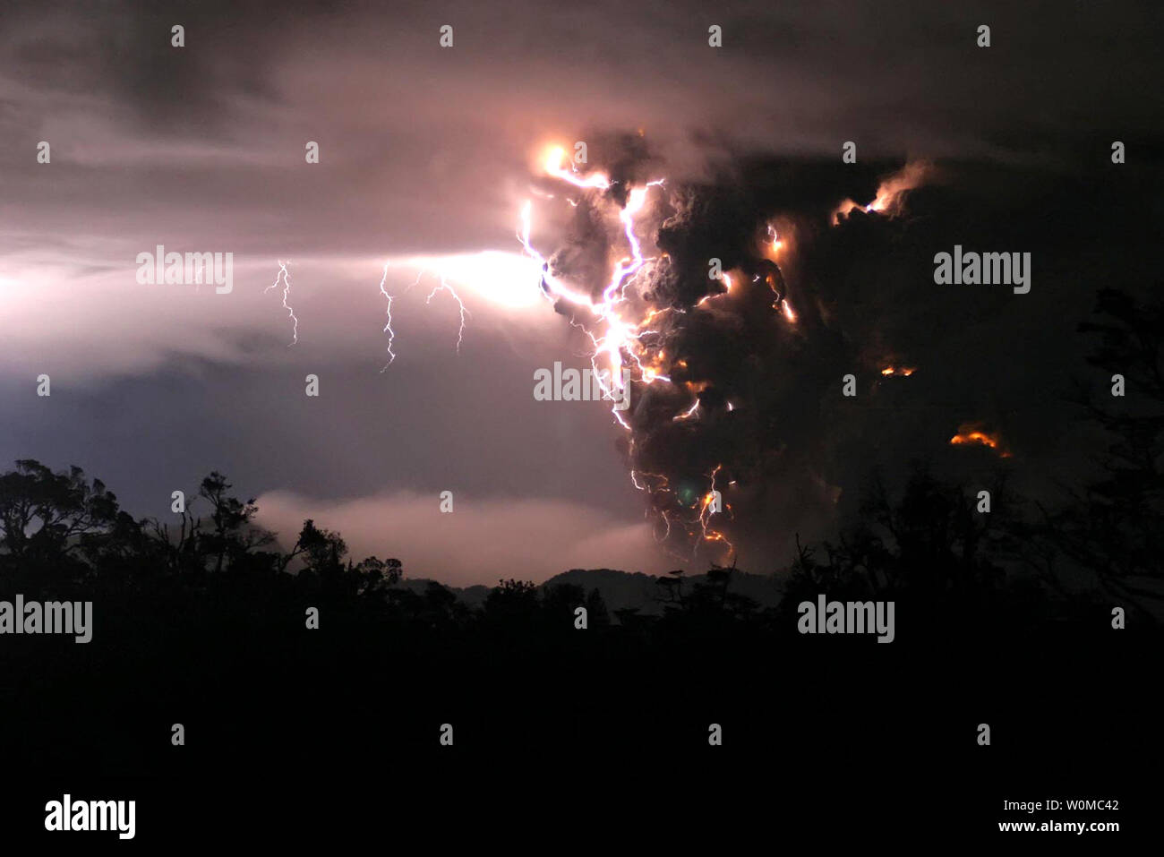 The Chaiten volcano erupts during storms in the middle of the night on May 3, 2008 in Chaiten, Chile.  The Chaiten volcano, located some 800 miles south of the capital Santiago, was considered dormant since it had not erupted for hundreds of years. Thousands of people have been evacuated from the area.   (UPI Photo/Carlos Gutierrez) Stock Photo