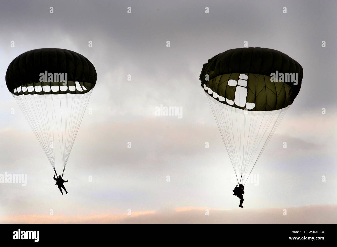 Two 786th Security Forces Squadron member parachute to the ground during a jump exercise on July 9, 2008 at an undisclosed location in Southern Germany.  (UPI Photo/Kenny Holston/U.S. Air Force) Stock Photo
