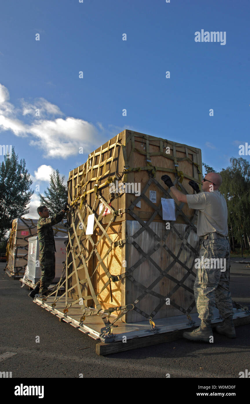 U.S. Air Force Airman 1st Class Rogelio Munoz and Tech. Sgt. Rogelio Parson, both from the 435th Logistics Readiness Squadron, prepares cargo that is part of the United States humanitarian assistance to the country of Georgia, from the Ramstein Air Base, Germany on August 13, 2008. (UPI Photo/Kenny Holston/U.S. Air Force) Stock Photo