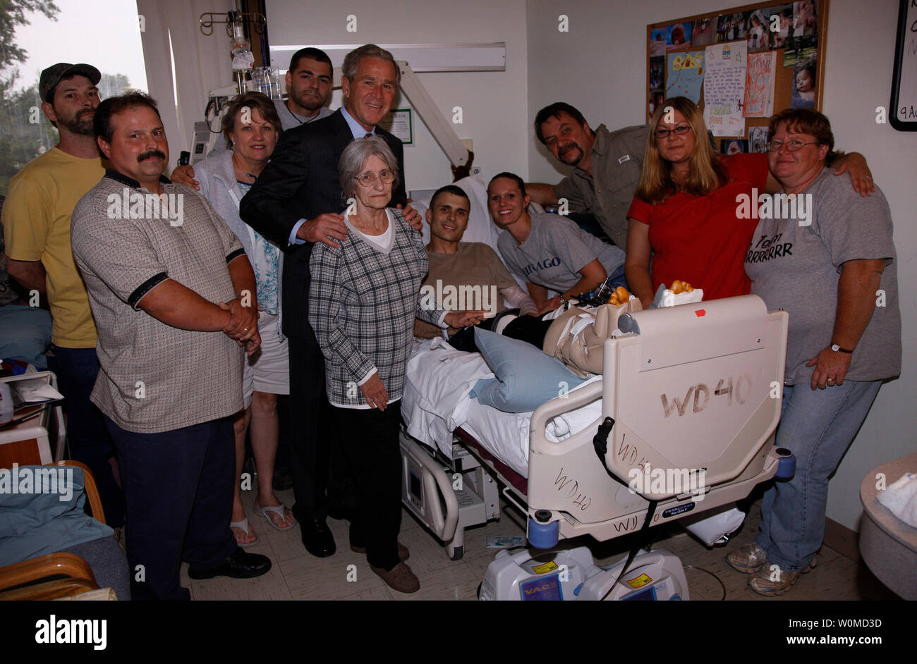 President George W. Bush stands with the extended family of U.S. Army Sgt. Jason Shepperly of Birmingham, Ala., during his visit September 9, 2008, to Walter Reed Army Medical Center, where the soldier is recovering from wounds received in Iraq.  (UPI Photo/ Eric Draper/White House) Stock Photo
