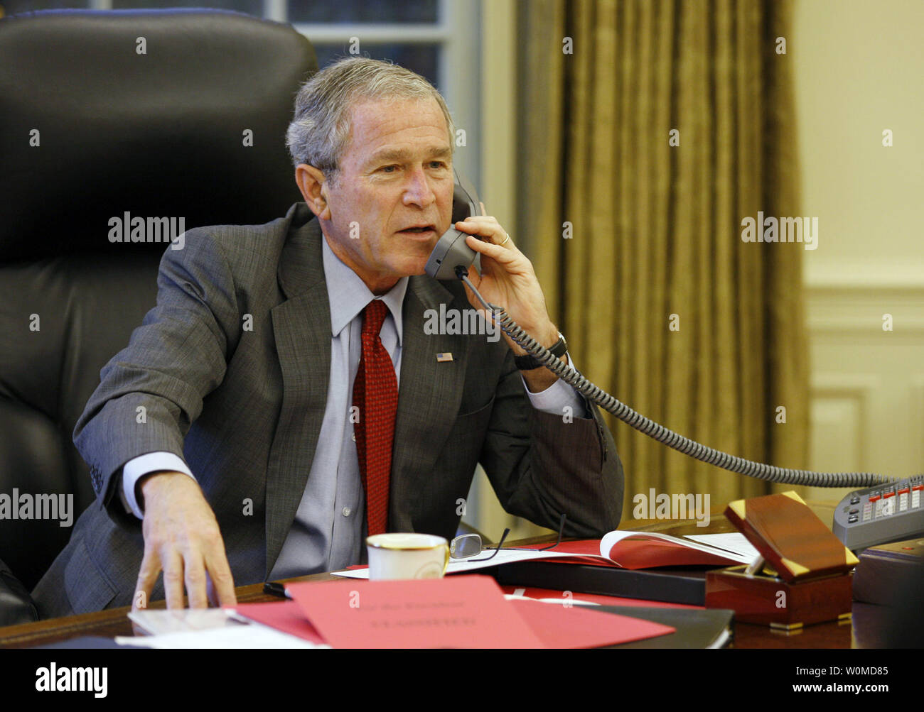 U.S. President George W. Bush speaks on the phone to British Prime Minister Gordon Brown about the financial crisis with British banks in the Oval Office of the White House in Washington on October 7, 2008. (UPI Photo/Eric Draper/White House Press Office) Stock Photo