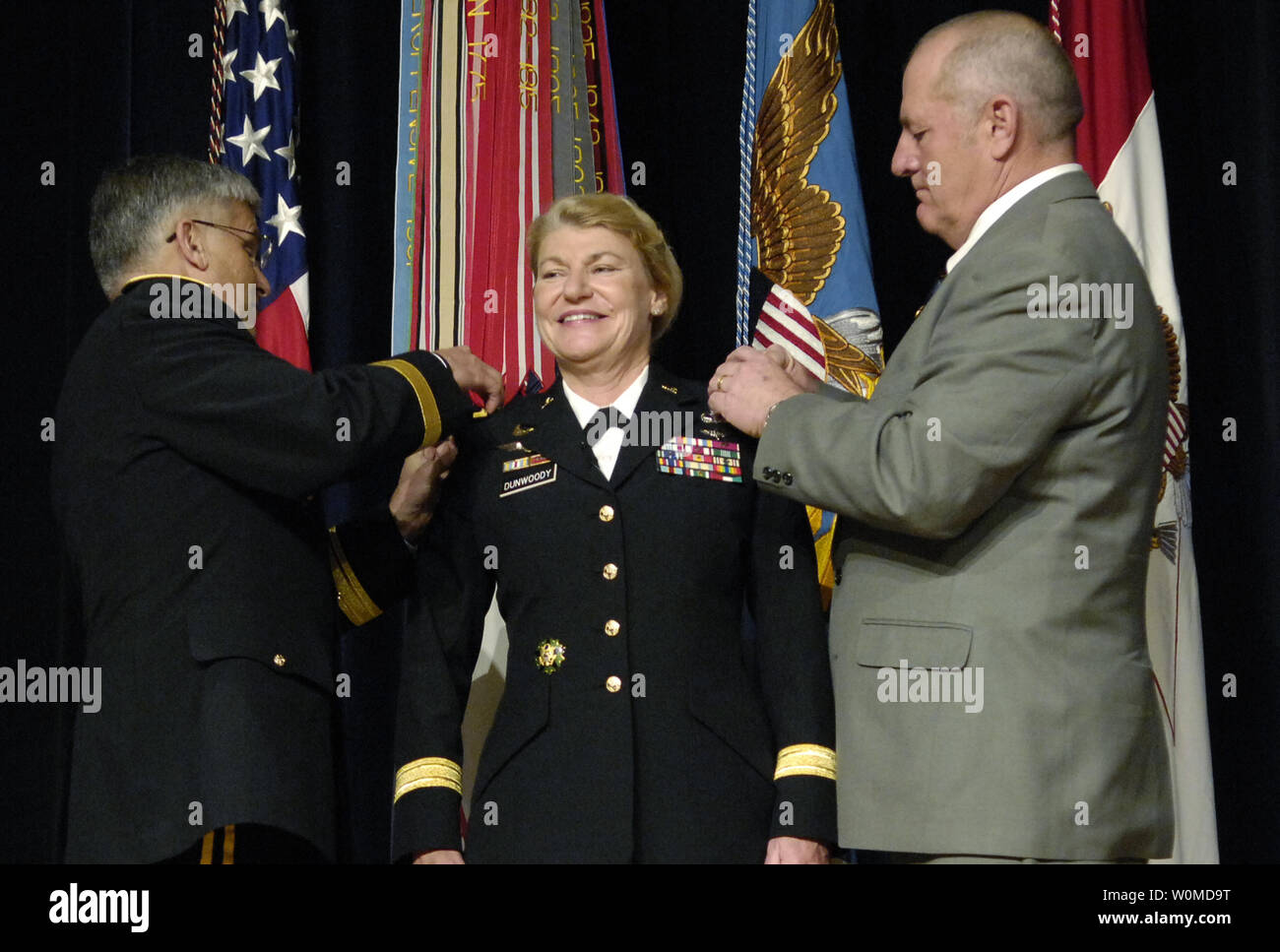 U.S. Army Ltg. Ann E. Dunwoody (C) smiles during her promotion to General, as she is pinned by Chief of Staff of the Army General George W. Casey (L) and her husband Craig Brotchie during a ceremony at the Pentagon in Arlington, Virginia on November 14, 2008.  Dunwoody made history as the United States' first 4 star female officer. (UPI Photo/Molly A. Burgess/U.S. Navy) Stock Photo