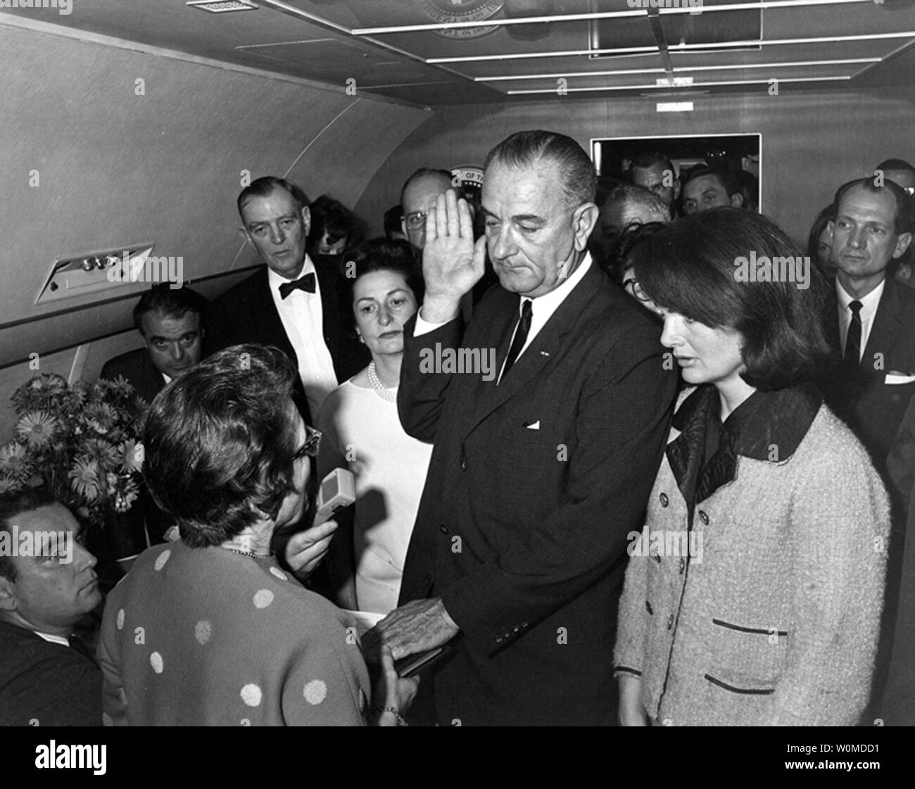 Judge Sarah T. Hughes administers the Presidential Oath of Office to Lyndon Baines Johnson aboard Air Force One, after President John F. Kennedy was assassinated, at Love Field in Dallas Texas on November 22, 1963. Mrs. Johnson, Mrs. Kennedy, Jack Valenti, Rep. Albert Thomas, Rep. Jack Brooks, Associate Press Secretary Malcolm Kilduff (holding microphone) and others witnesses attend. November 22, 2008 marks the 45th anniversary of the day President Kennedy was assassinated in Dallas, Texas. (UPI Photo/Cecil Stoughton/John F. Kennedy Presidential Library & Museum) Stock Photo