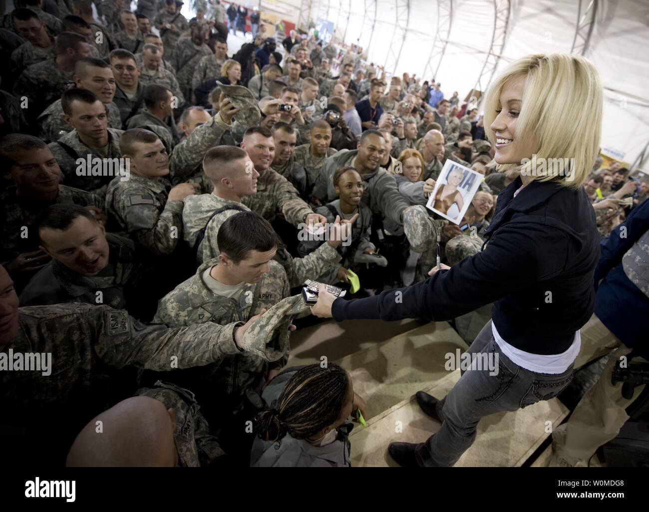 Country musician Kellie Pickler signs autographs after performing for U.S. service members during a stop on the 2008 USO Holiday Tour in Kandahar, Afghanistan on December 17, 2008. (UPI Photo/Chad J. McNeeley/U.S. Navy) Stock Photo