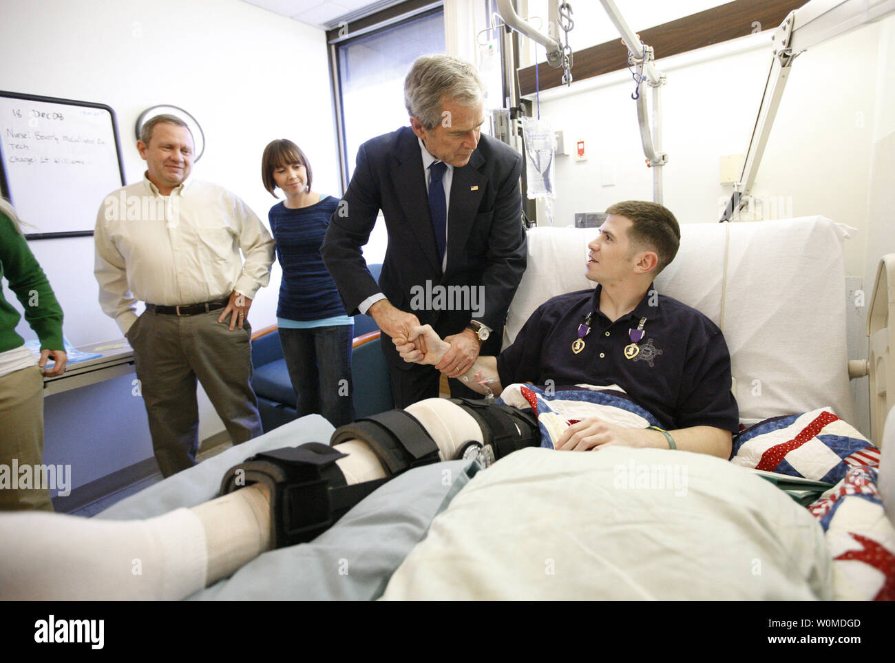 President George W. Bush shakes hands with U.S. Army Staff Sgt.  Kyle Stipp of Avon, Indiana, after presenting him with two Purple Hearts on December 22, 2008 in Washington D.C., during a visit to Walter Reed Army Medical Center where the soldier is recovering from wounds suffered in the war in Iraq.   (UPI Photo/Eric Draper/White House) Stock Photo