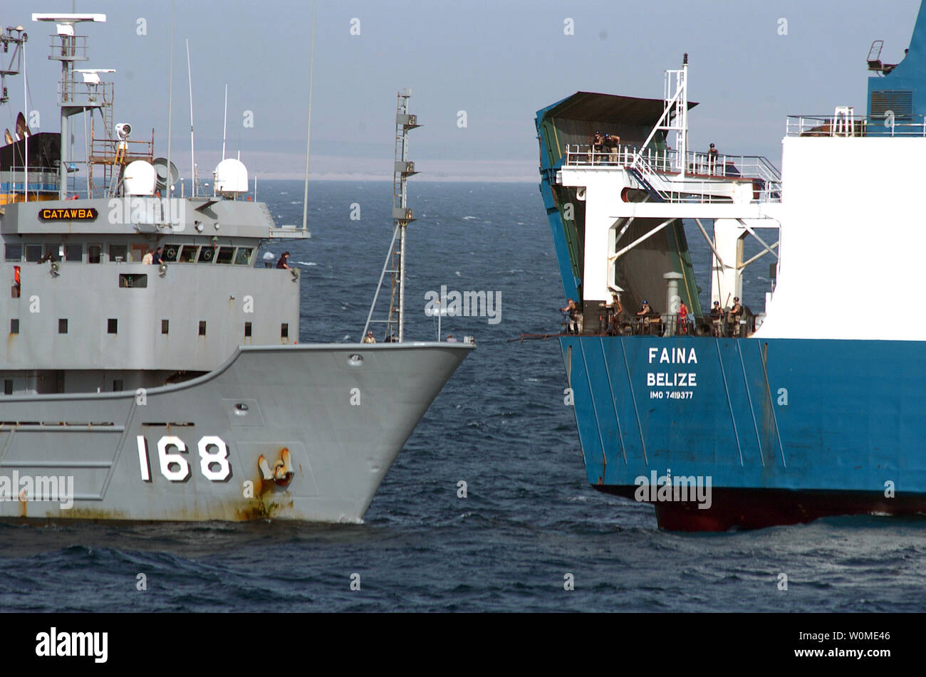 The U.S. Navy fleet ocean tug USNS Catawba (L) provides fuel and fresh water to Motor Vessel Faina following its release by Somali pirates on February 5, 2009. Somali pirates released the Motor Vessel Faina after holding it since September 25, 2008. The U.S. Navy has remained within visual range of the ship and maintained a 24-hour, 7-days a week presence since it was captured.  The Belize-flagged cargo ship is owned and operated by 'Kaalbye Shipping Ukraine' and is carrying a cargo of Ukrainian T-72 tanks and related equipment. (UPI Photo/Michael R. McCormick/U.S. Navy) Stock Photo