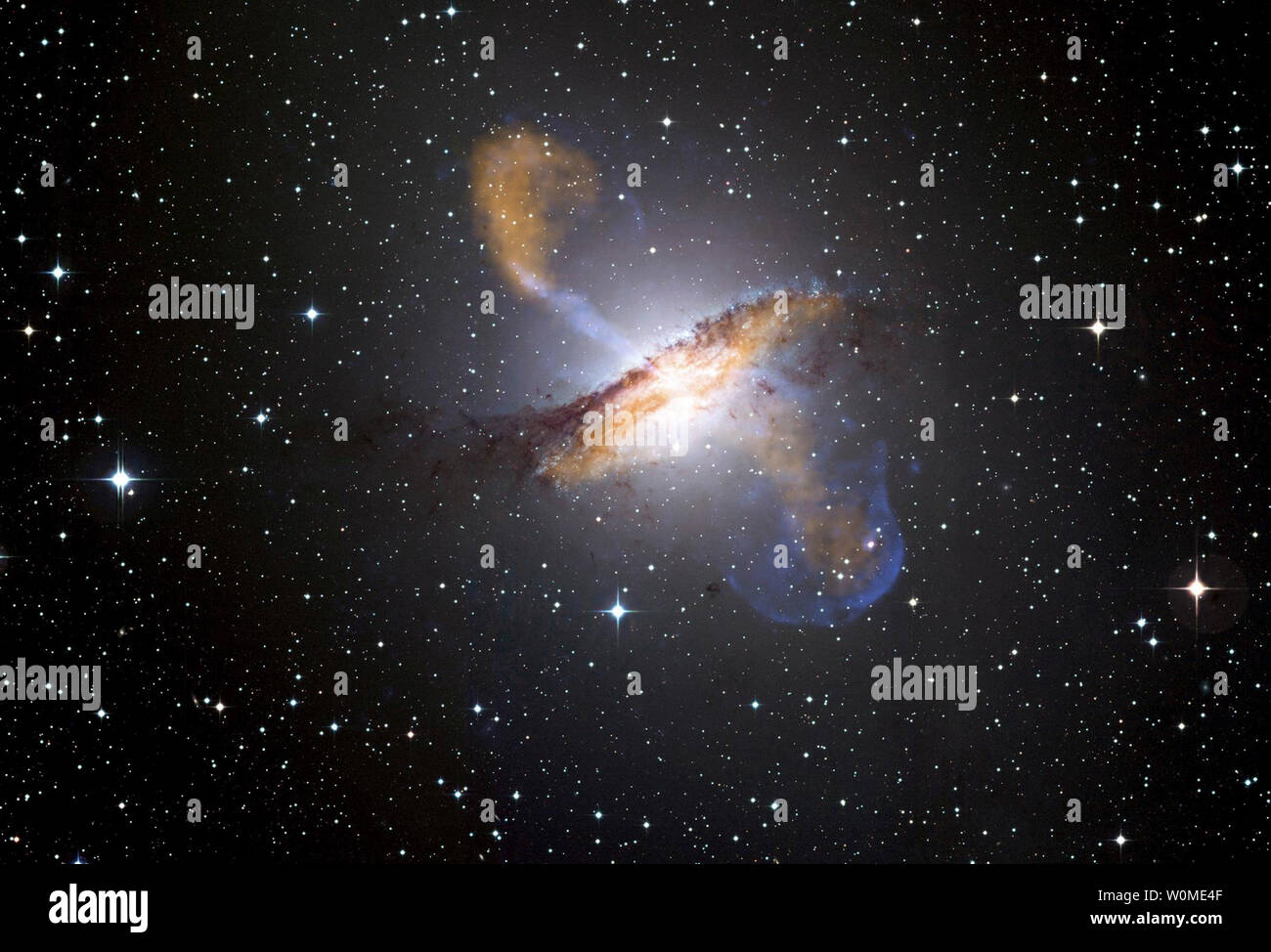 This undated NASA image of galaxy Centaurus A shows the jets and lobes of the supermassive black hole at the central of the galaxy. This image was captured by the Atacama Pathfinder Experiment (APEX) telescope in Chile and X-ray data (colored blue) from the Chandra X-ray Observatory. (UPI Photo/NASA) Stock Photo