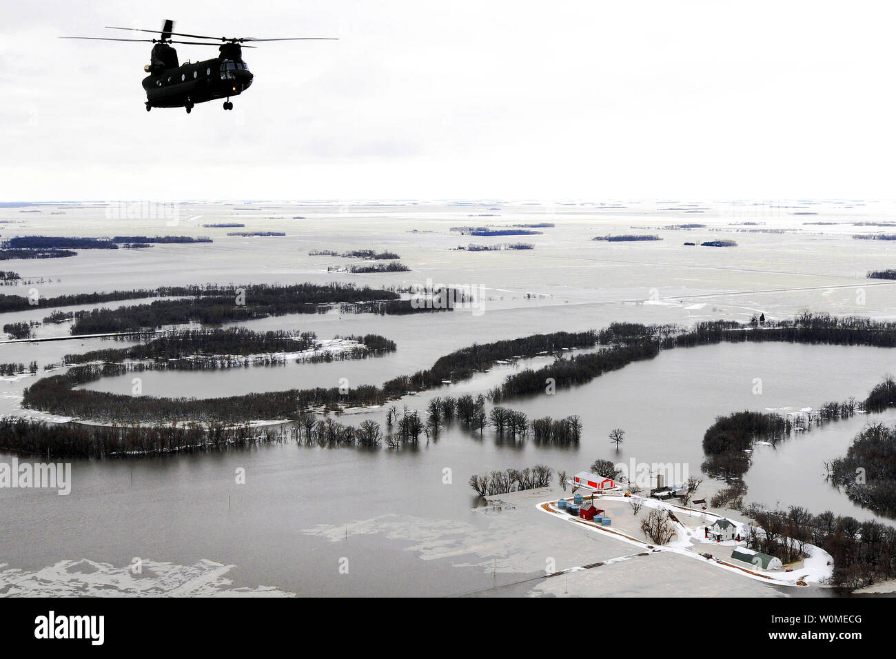 A Montana Army National Guard CH-47D Chinook helicopter flies over the North Dakota/Minnesota border area flooded by the Red River, April 1, 2009.  (UPI Photo/Roger M. Dey/US Army) Stock Photo