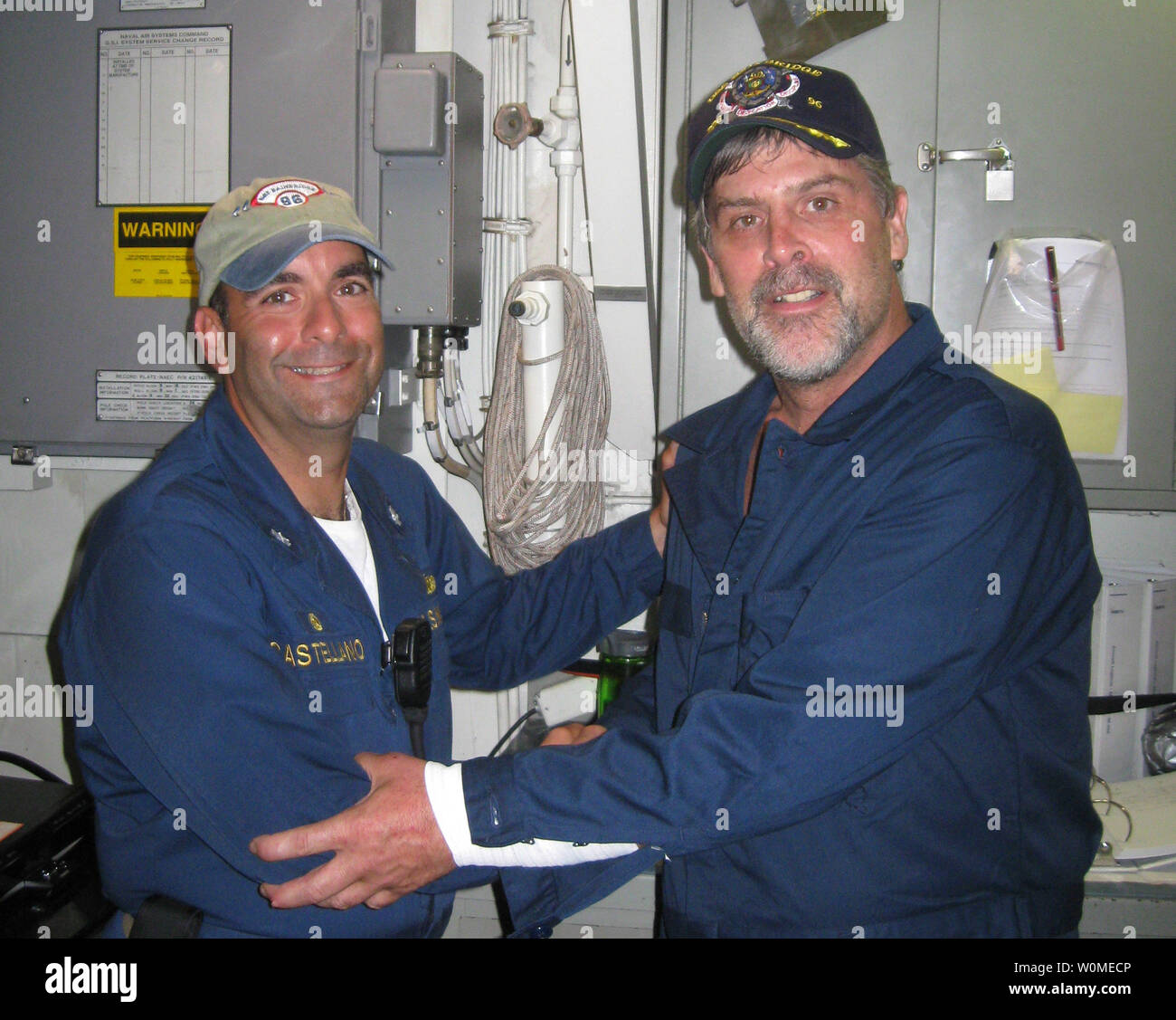 Maersk-Alabama Capt. Richard Phillips, right, stands alongside Cmdr. Frank Castellano, commanding officer of USS Bainbridge after Phillips was rescued by U.S Naval forces off the coast of Somalia on April 12, 2009. Philips was held hostage for four days by pirates. US Navy SEALs shot dead three pirates when they felt he was in imminent danger as the pirates pointed an AK-47 rifle at him.    (UPI Photo/U.S. Navy Photo) Stock Photo