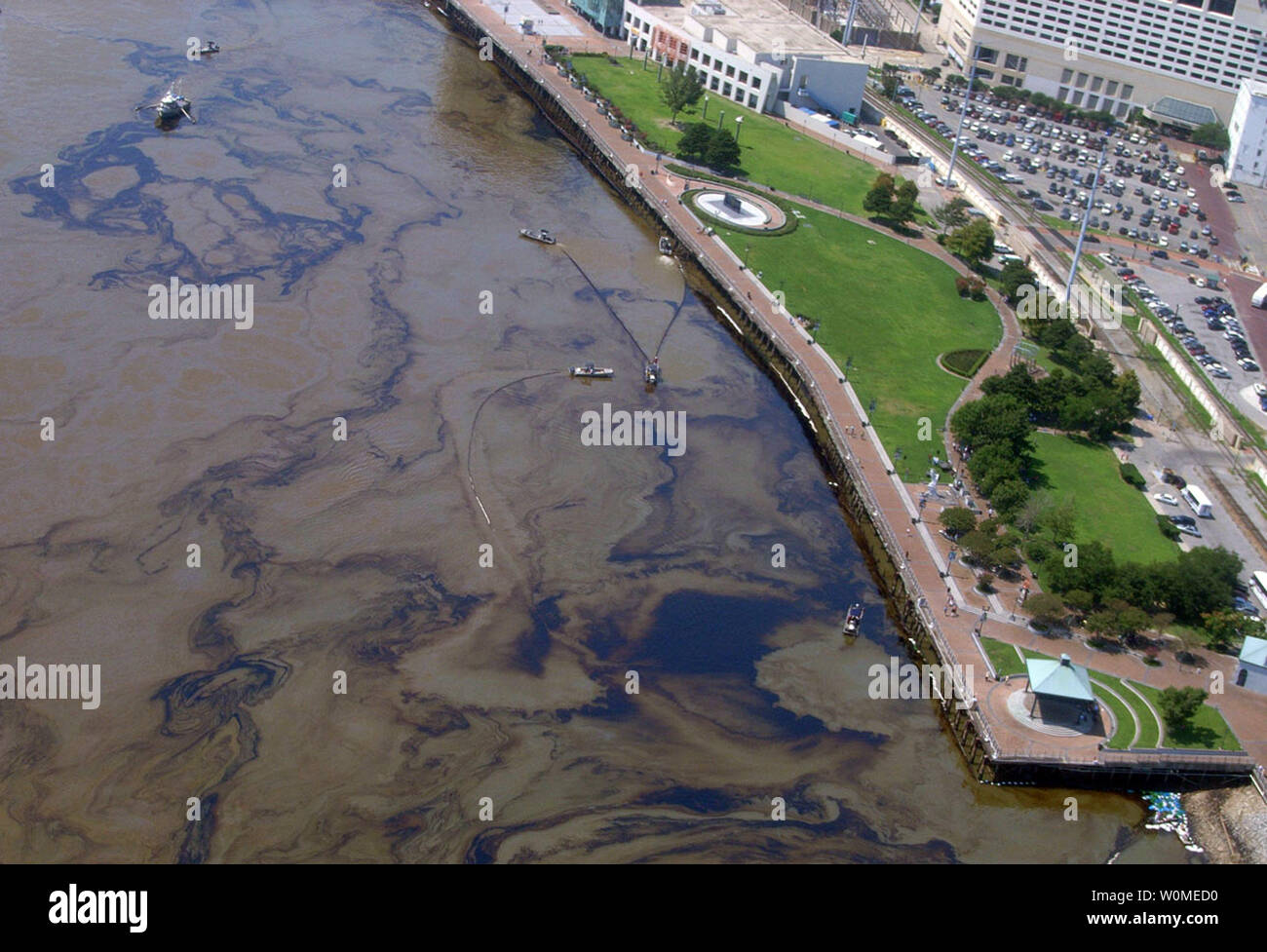 This National Oceanic and Atmospheric Administration photo shows an aerial view of Waldenberg Park and skimmers cleaning up oil following a massive oil spill in 2007. The Cosco Busan, a container ship, dumped 58,000 gallons of oil after striking the San Francisco Bay bridge in California. Oil streamers are a result from the lifting of the damaged barge.     (UPI Photo/NOAA) Stock Photo