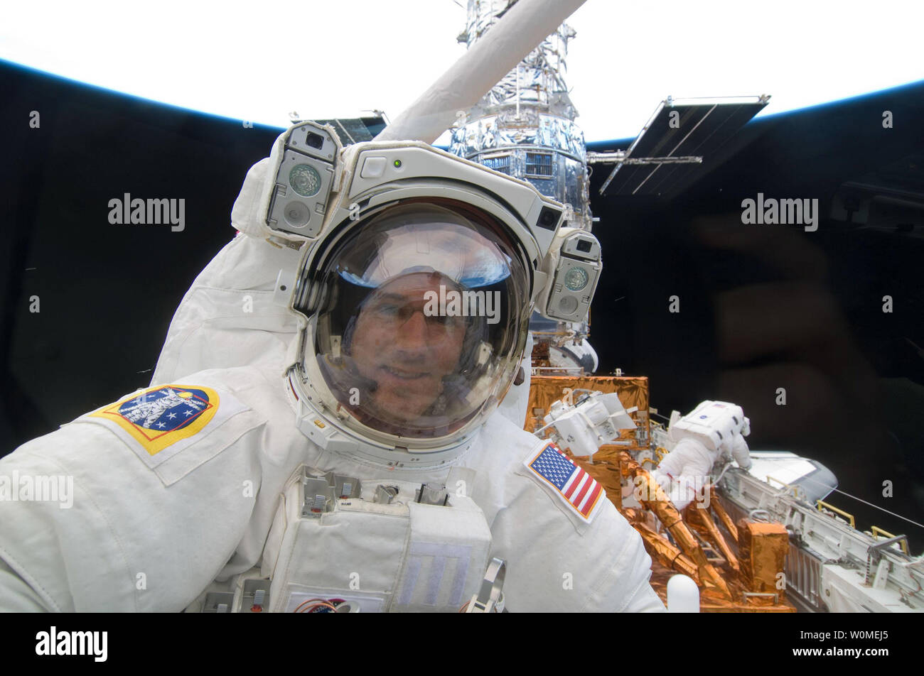 Astronaut Michael Good Peers Through A Window Toward Space