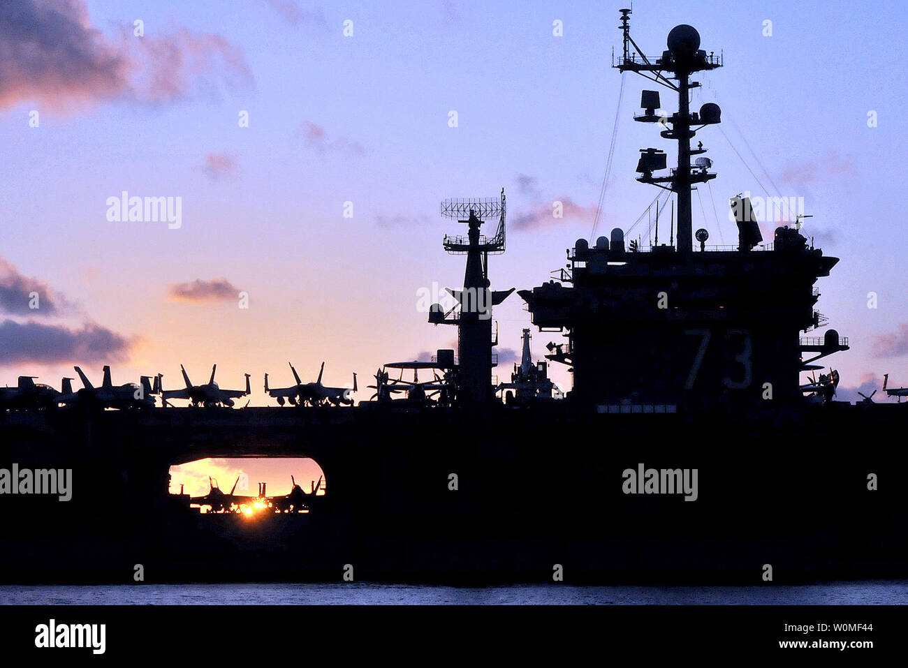 The aircraft carrier USS George Washington (CVN 73) is silhouetted as it transits the western Pacific Ocean at sunrise, July 24, 2009.    UPI/John M. Hageman/DOD Stock Photo