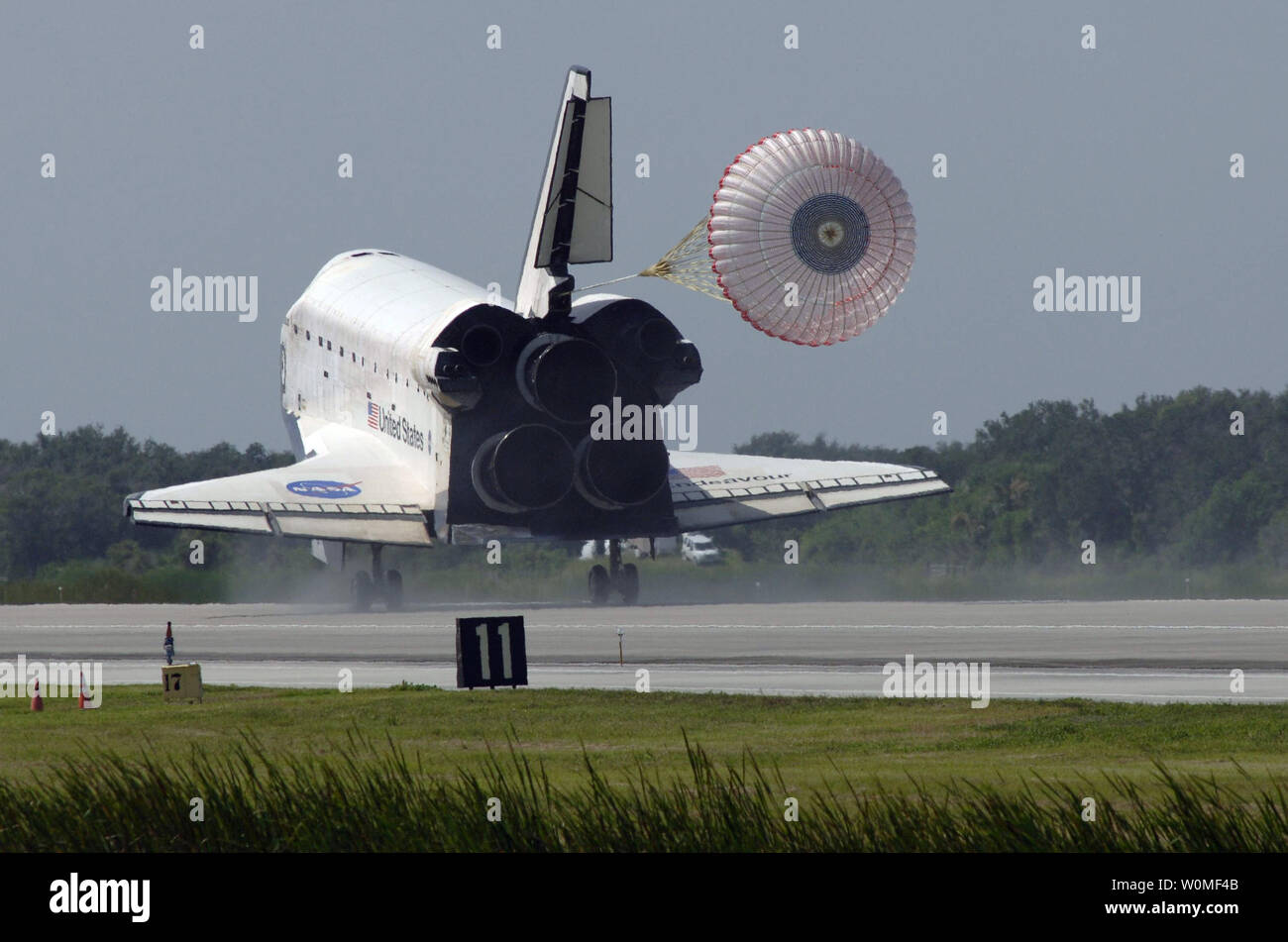 The drogue chute unfurls behind space shuttle Endeavour on Runway 15 at  NASA's Kennedy Space Center in Florida to complete the 16-day, 6.5-million  mile journey on the STS-127 mission to the International