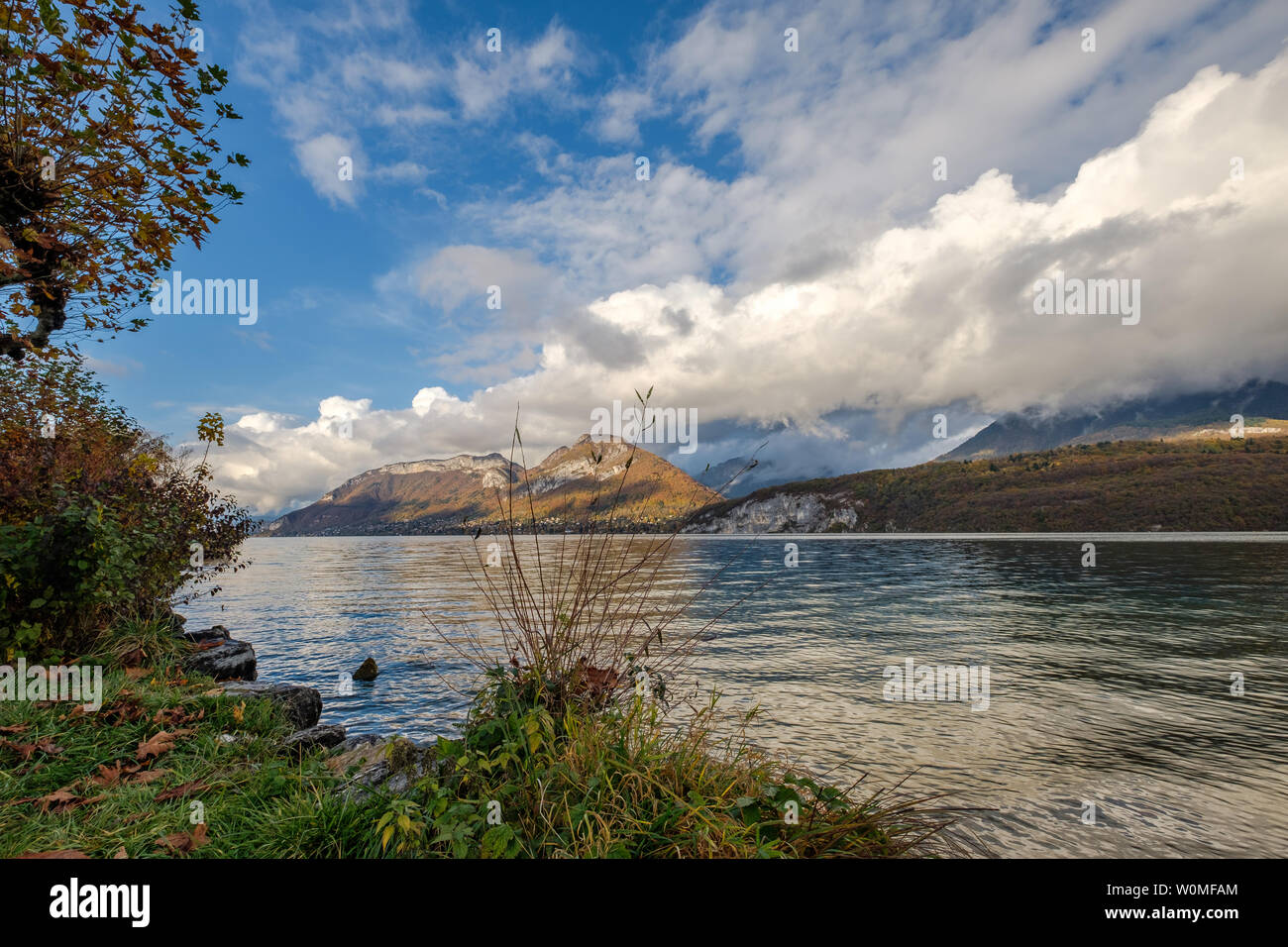 A beautiful fall view from a low angle on Lake Annecy, France, with mountains with low clouds in the background Stock Photo