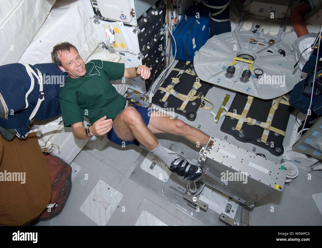 This NASA image taken by astronauts aboard Space Shuttle Discovery on mission STS-128 shows European Space Agency astronaut Christer Fuglesang, STS-128 mission specialist, exercising on a bicycle ergometer on the middeck of the Earth-orbiting Space Shuttle Discovery, August 29, 2009.  UPI/NASA Stock Photo