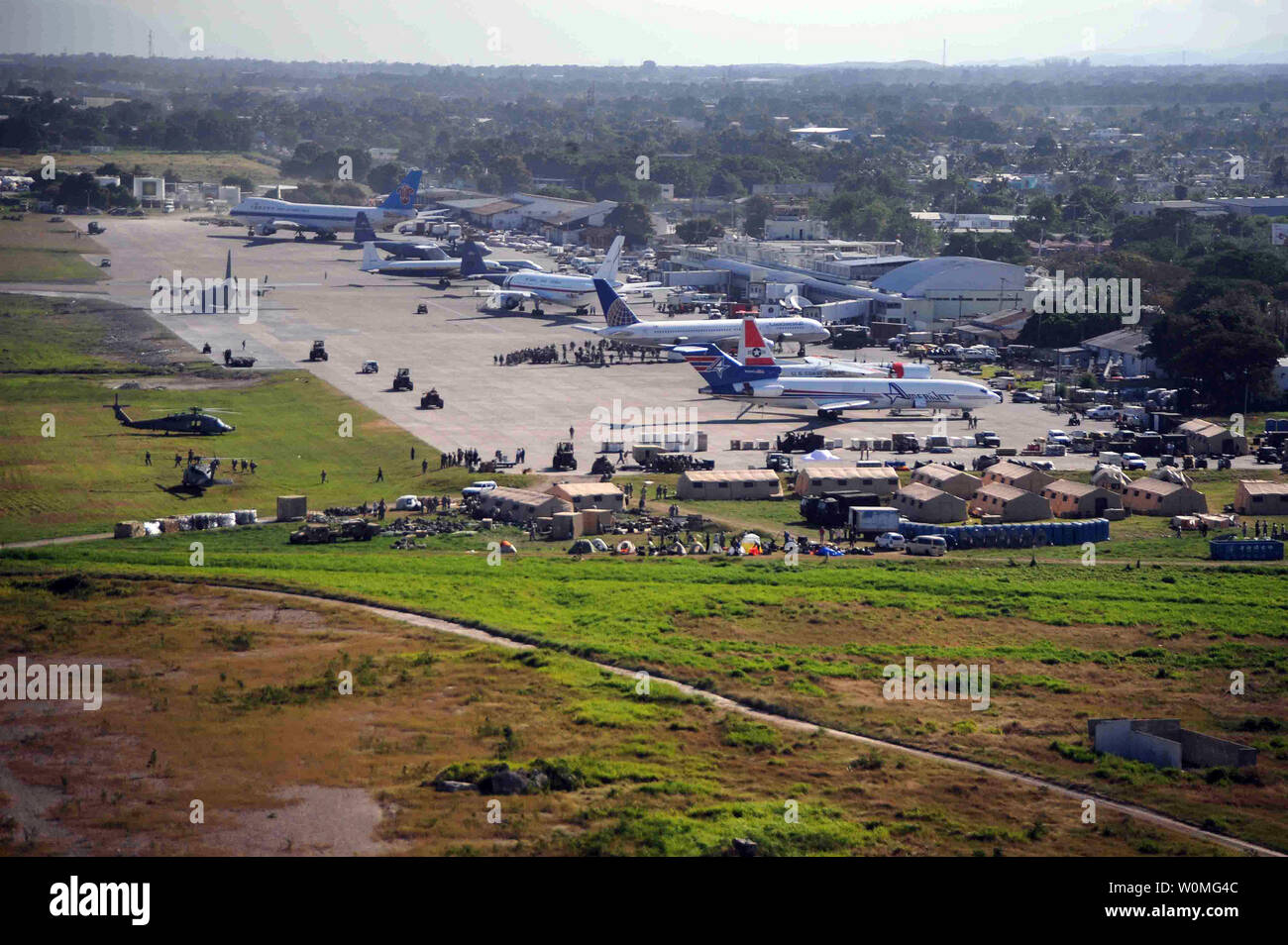 Airplanes wait for off-load to support in earthquake relief efforts at the Port-au-Prince International Airport in Haiti on January 17, 2010. Part-au-Prince was hit by a devastating 7.0 magnitude earthquake on Jan. 12, 2010.  UPI/Justin Stumberg/US Navy Stock Photo