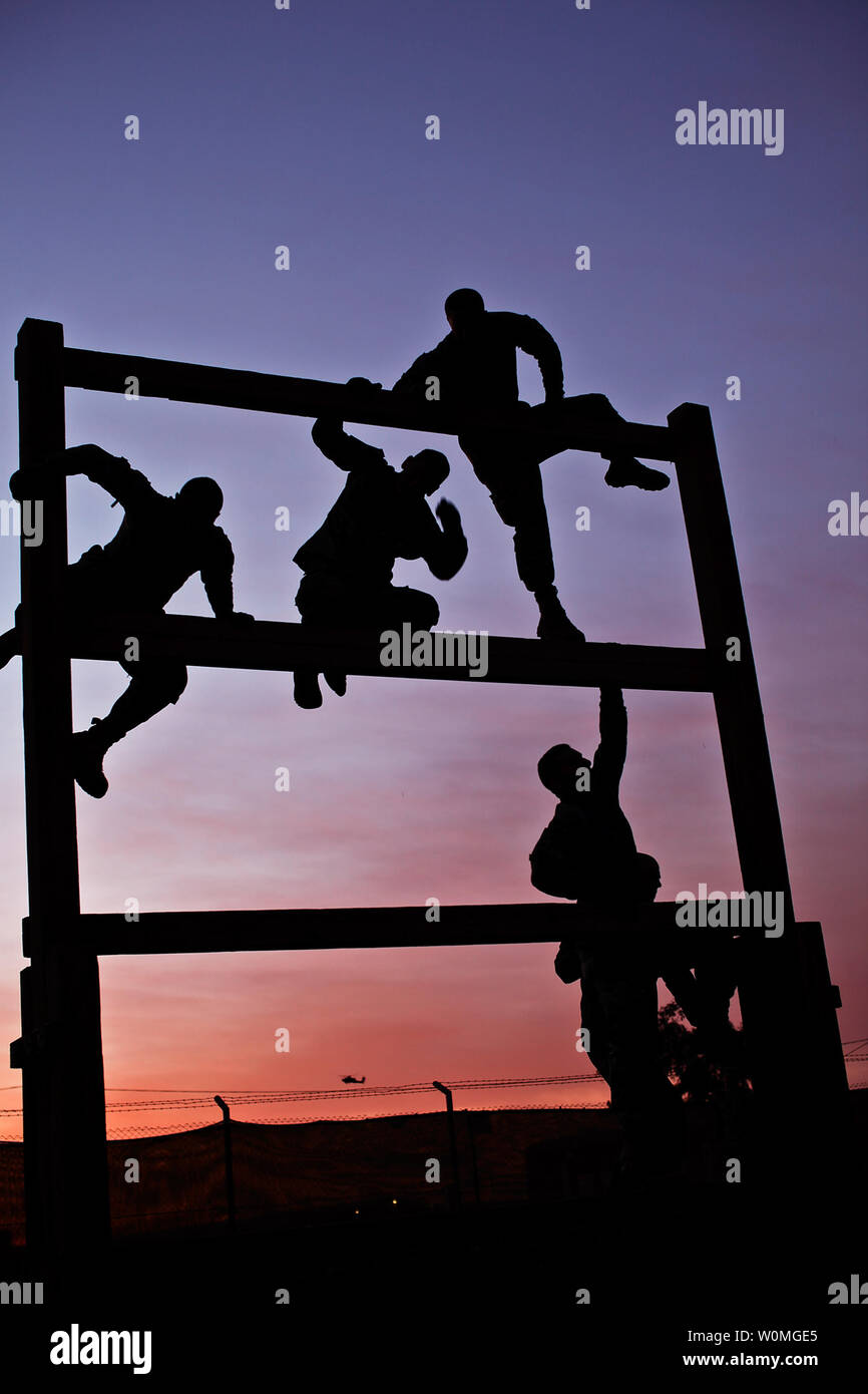 Soldiers from Company F, 3rd Battalion, 227th Aviation Regiment, 1st Air Cavalry Brigade, 1st Cavalry Division, U.S. Division Center, climb through an obstacle course at sunrise at Camp Taji, Iraq on March 23, 2010. UPI/Travis Zielinski/U.S. Air Force Stock Photo