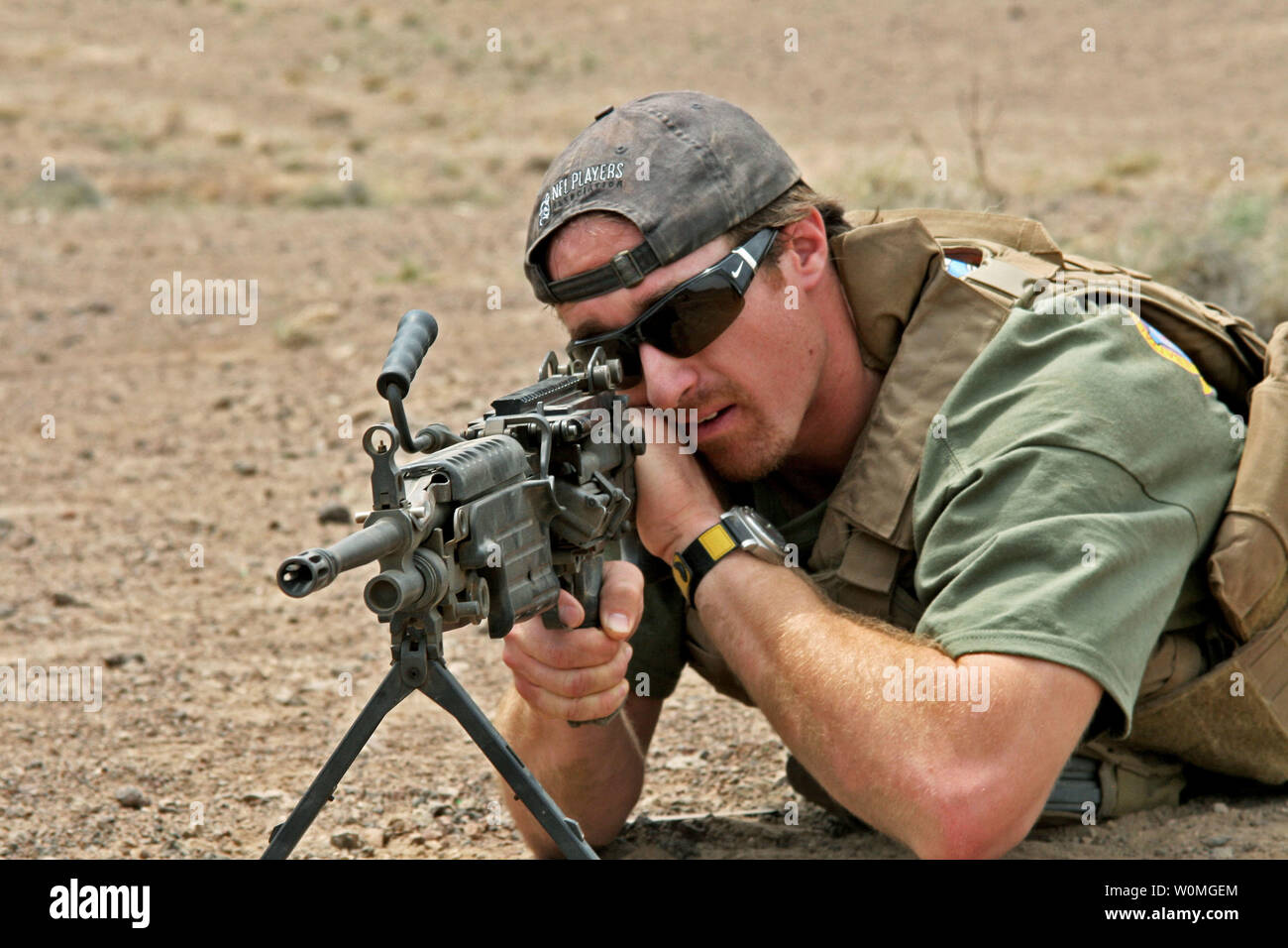 New Orleans Saints quarterback Drew Brees looks through the sights of an M249 Squad Automatic Weapon during a visit to Marines assigned to the 24th Marine Expeditionary Unit (24th MEU) March 29, 2010 in Djibouti during a USO tour. UPI/James Frank/U.S. Navy Stock Photo