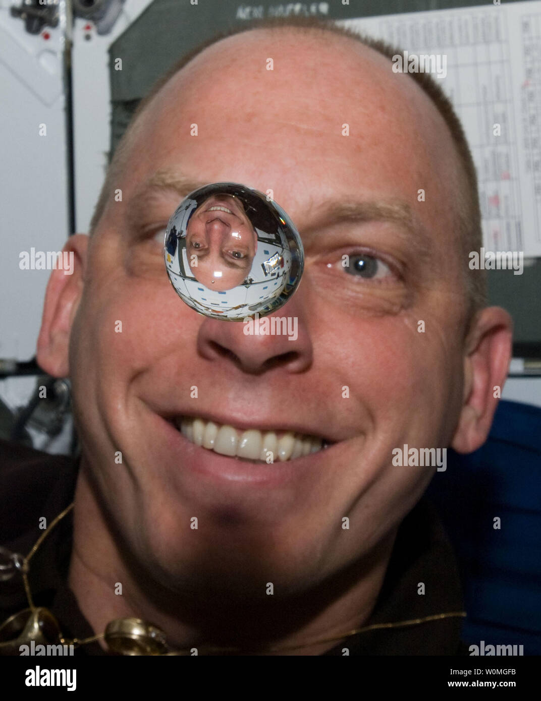 Humble Whimsical Staple NASA astronaut Clayton Anderson, STS-131 mission specialist, watches a  water bubble float freely between him and the camera, showing his image  refracted, on the middeck of space shuttle Discovery while docked with