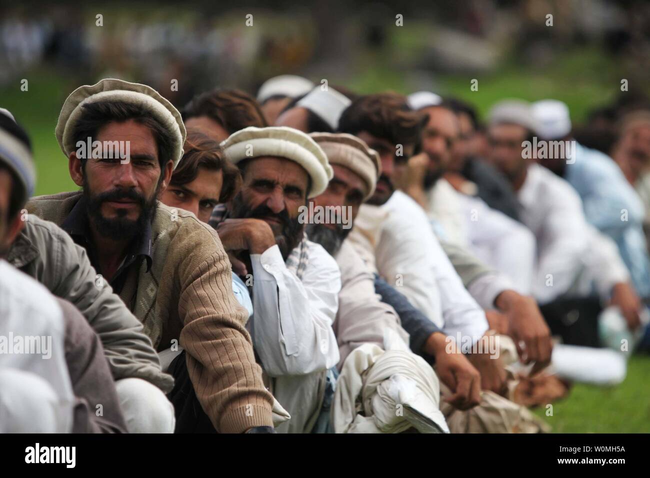 Pakistani civilians wait to board a CH-53E Super Stallion helicopter during humanitarian relief efforts in the Khyber-Pakhtunkhwa province, Pakistan on August 18, 2010 after massive floods devastated the country.  UPI/Paul Duncan/U.S. Military Stock Photo