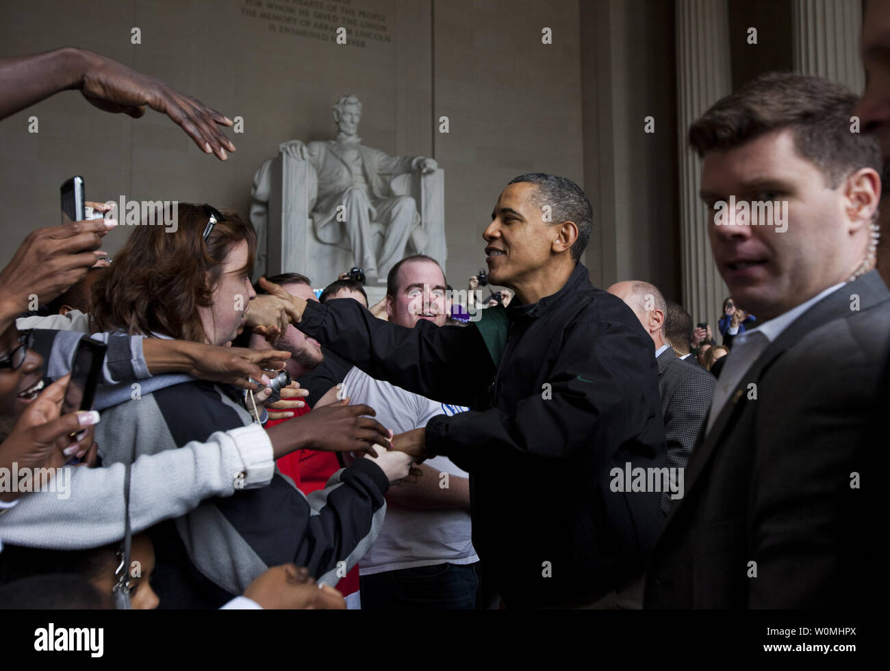 U.S. President Barack Obama shakes the hands of tourists visiting the Lincoln Memorial during a surprise visit a day after budget negotiations with Congress prevented a government shutdown in Washington, DC, on 9 April, 2011.  UPI/Jim Lo Scalzo Stock Photo